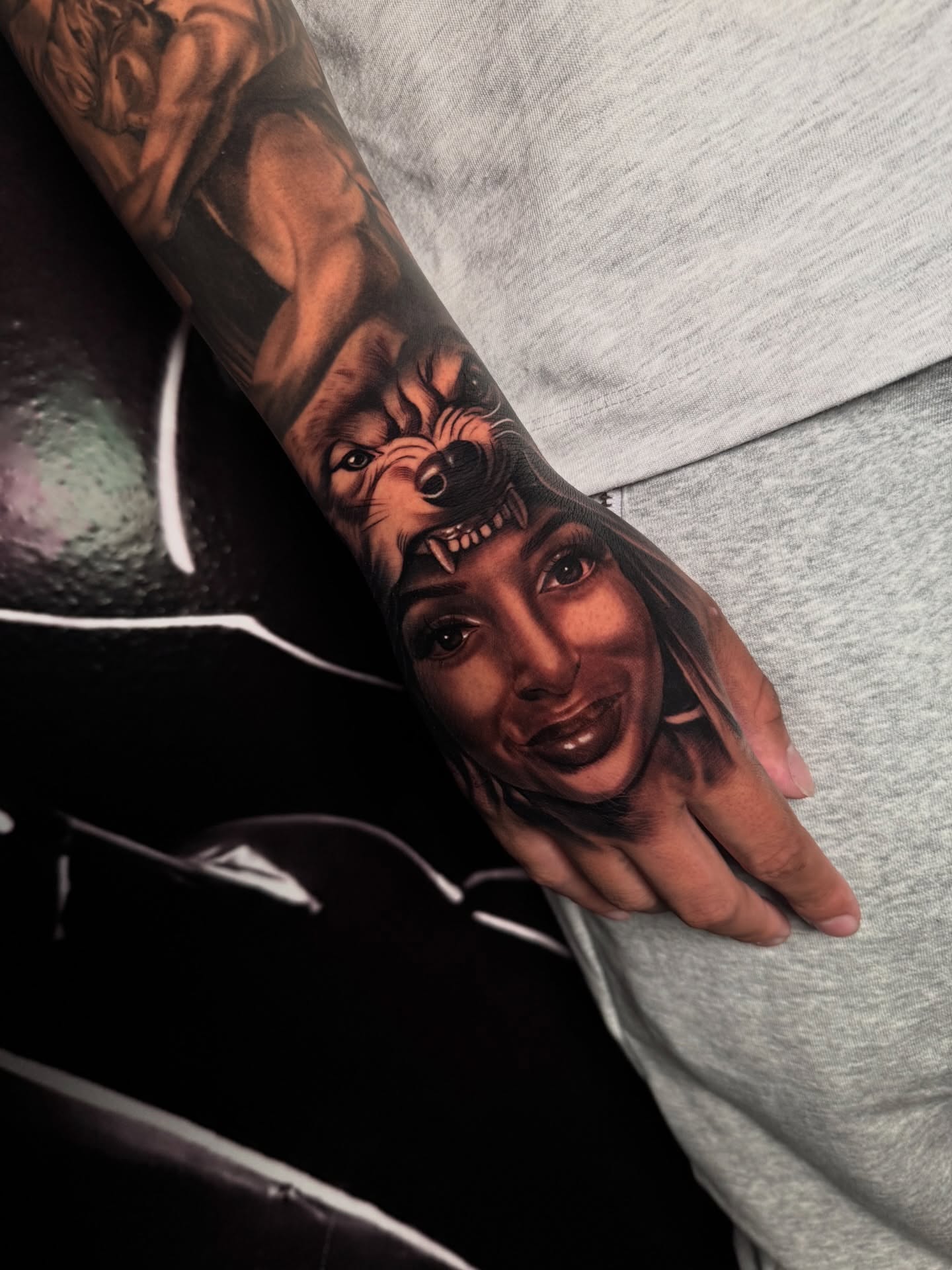 Portrait realism tattoo on the forearm by Yudel