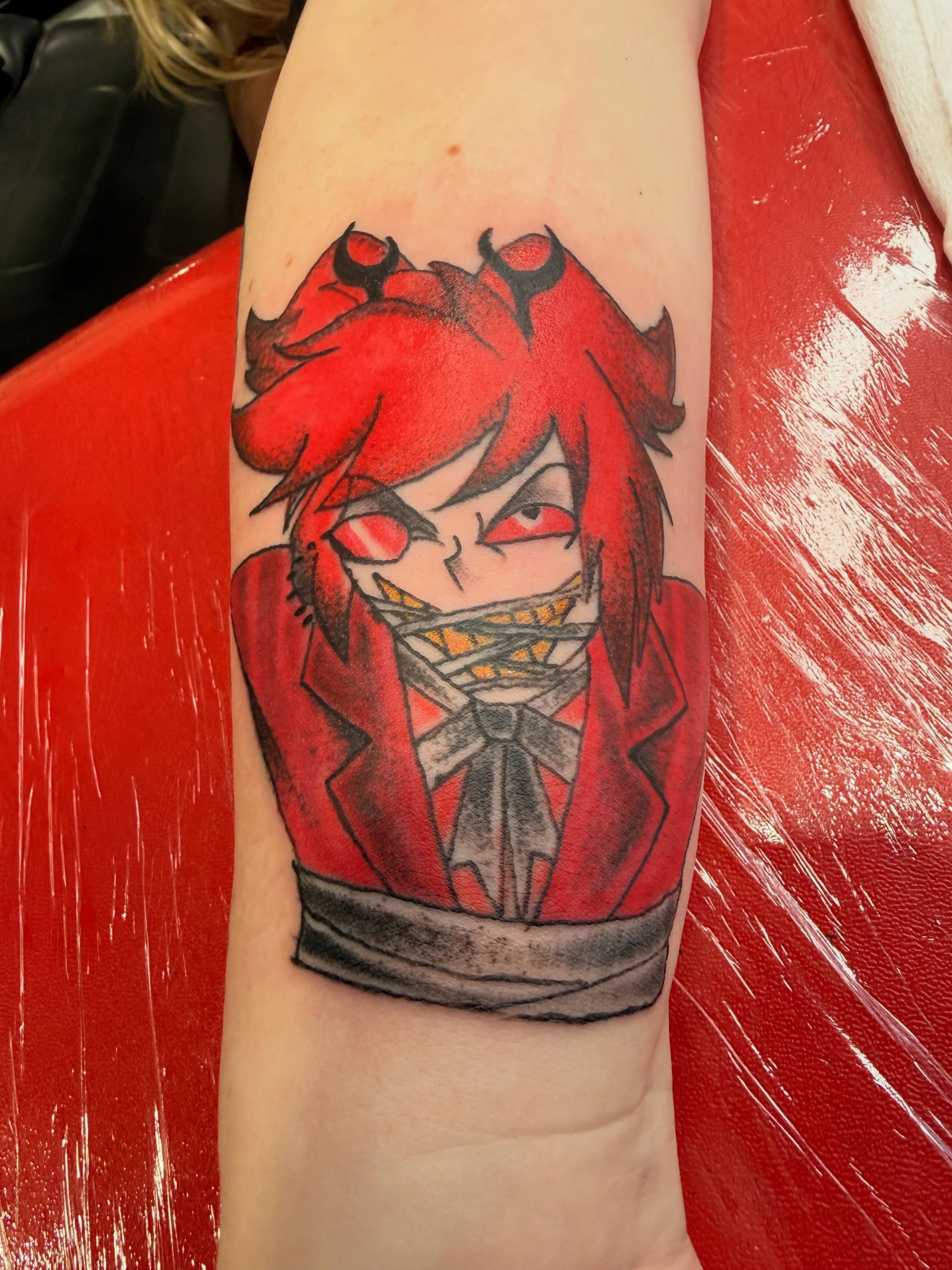 Red-haired character anime tattoo on the forearm by Jones Eric