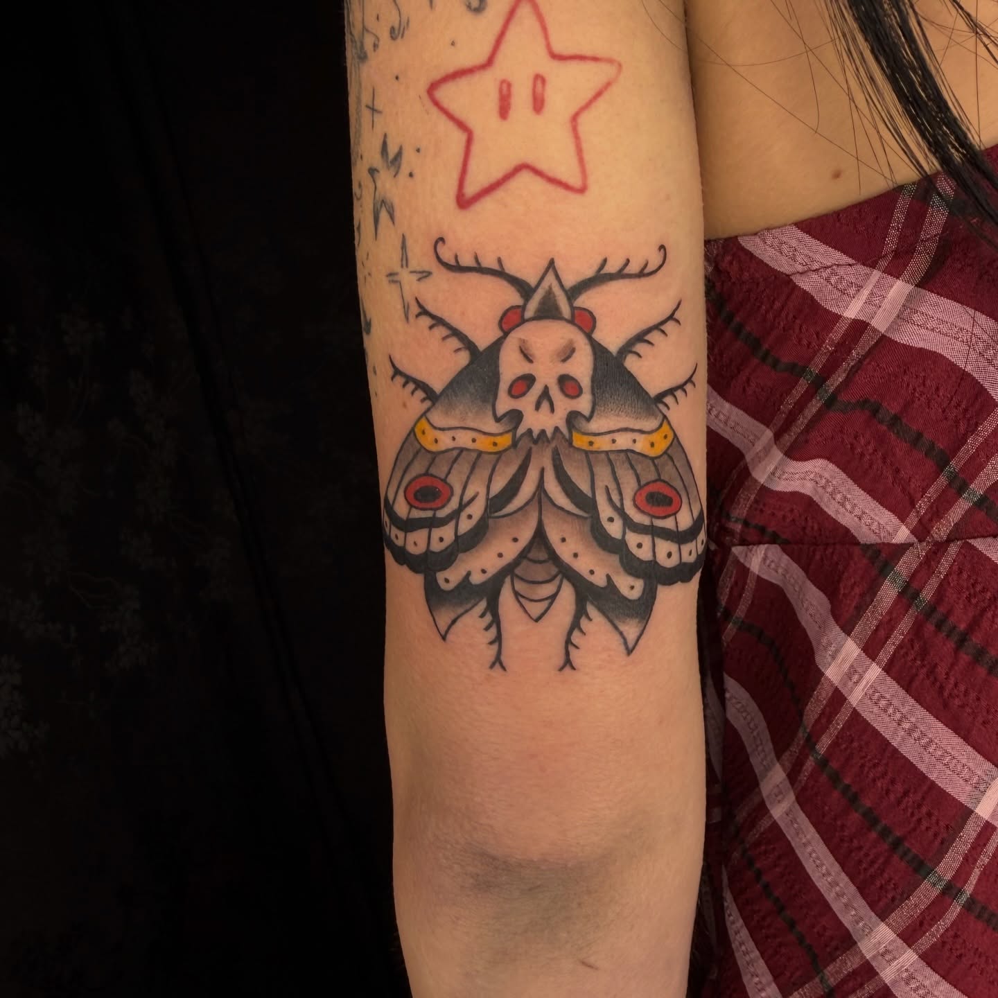 Skull moth American traditional tattoo on the forearm by Kaysen
