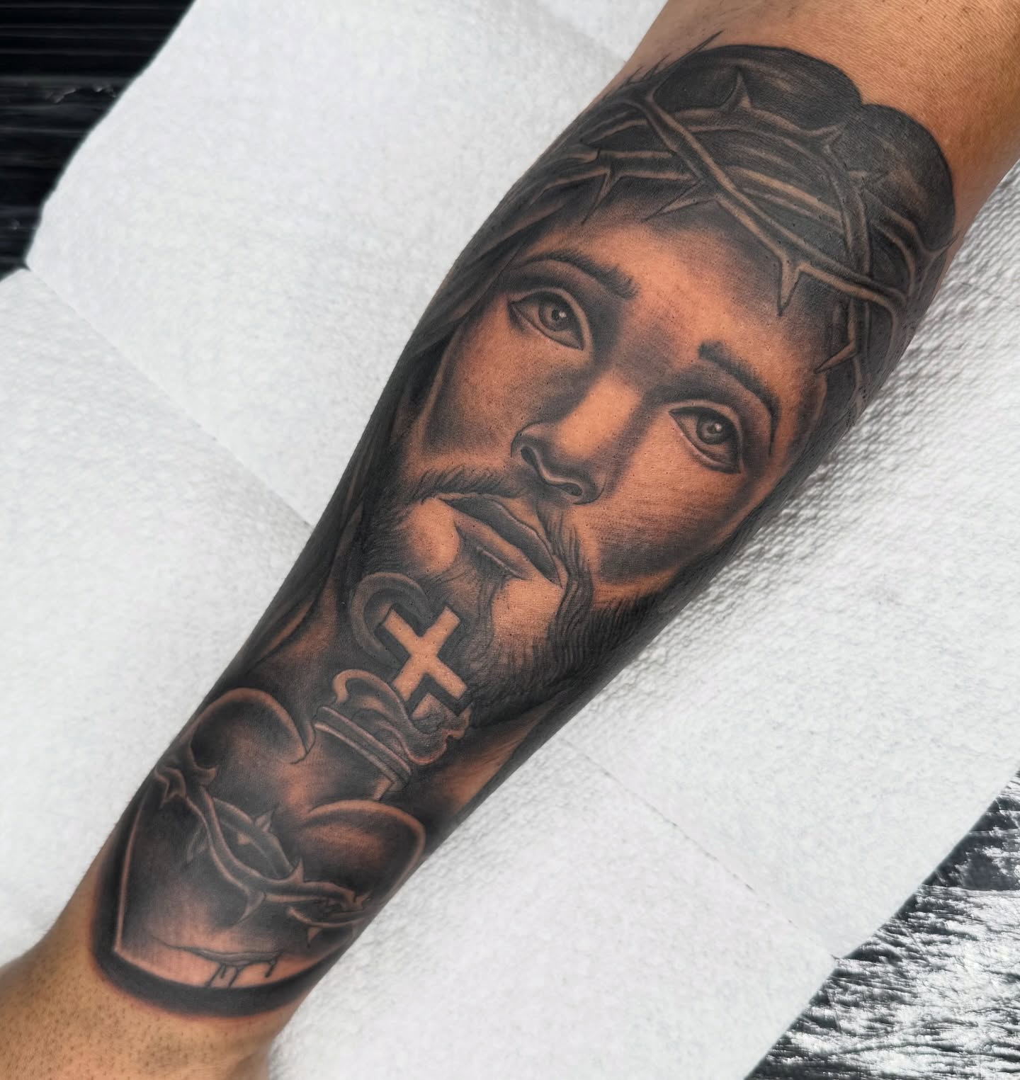 Religious figure realism tattoo on the forearm by Elijah East
