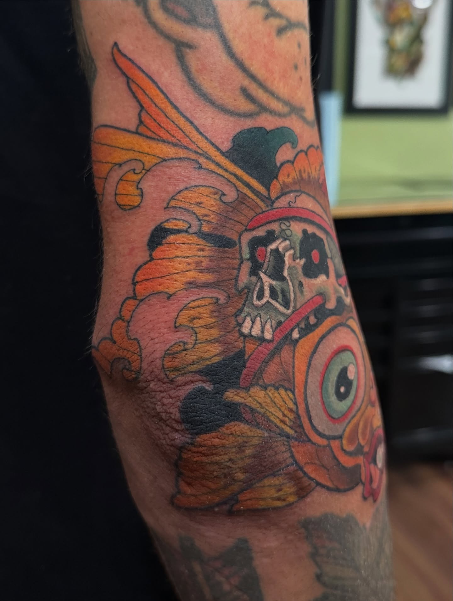 Skull and mask American traditional tattoo on the forearm by Trevor Burtz