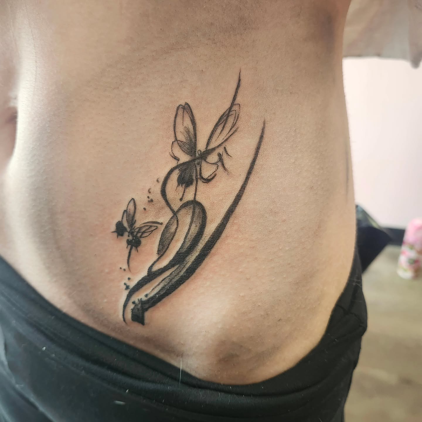 Butterfly and flower black and grey tattoo on the ribs by Meredith 🎈 Tattoo the Bride ✝️