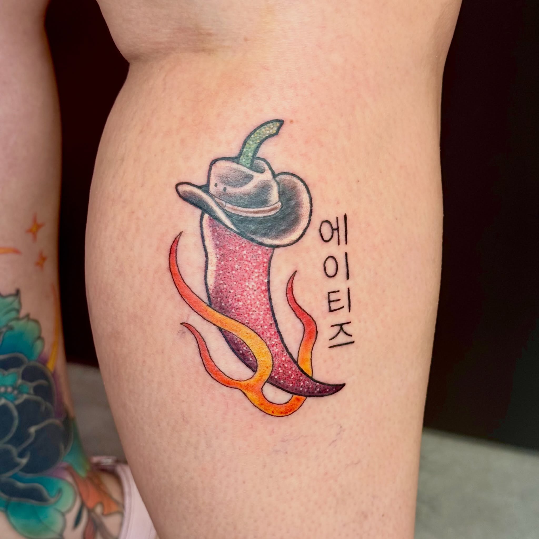 Chili pepper with cowboy hat American traditional tattoo on the thigh by Caitlynn Austin