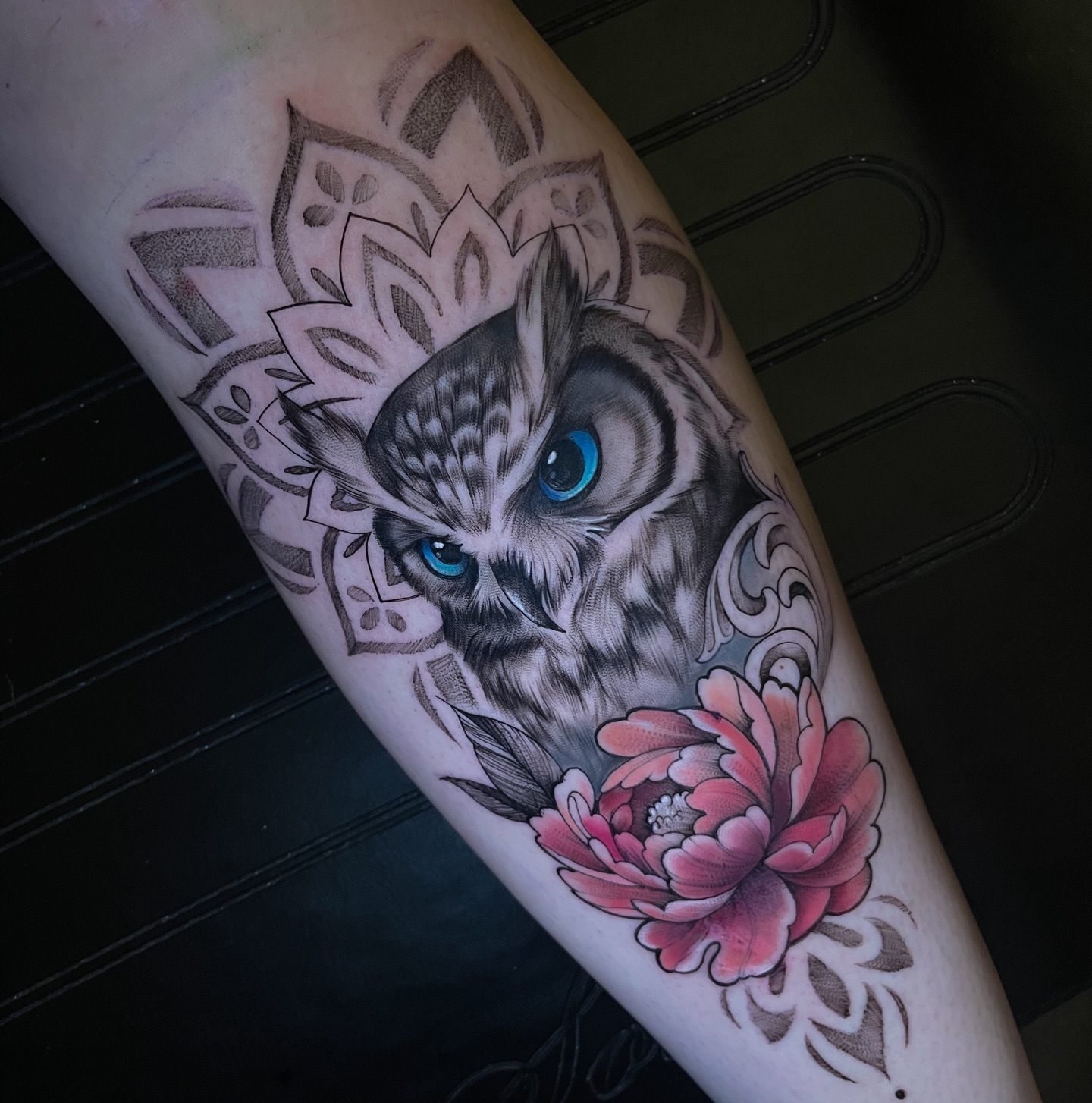 Owl and flower realism tattoo on the forearm by Erica Olivier