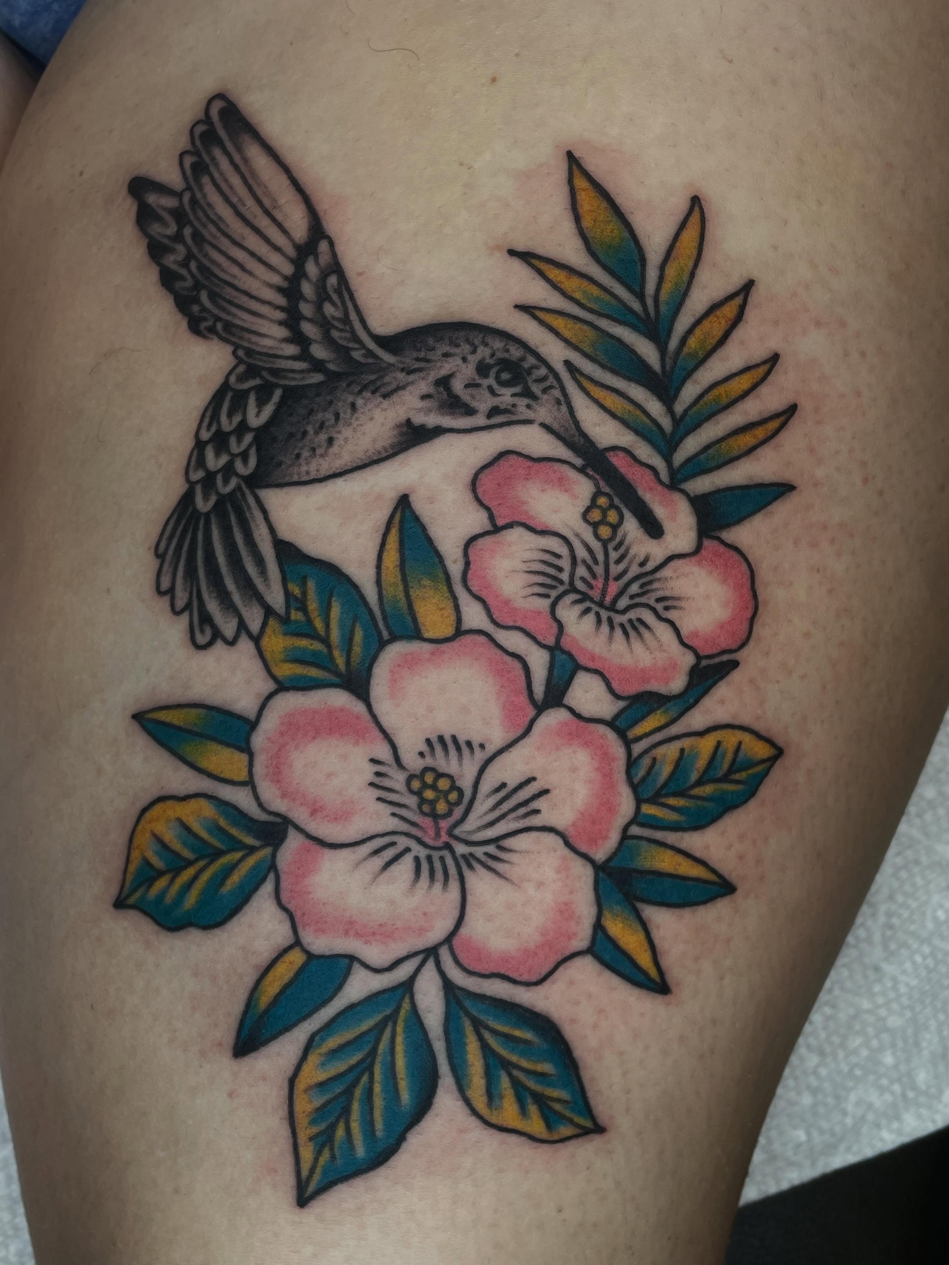Hummingbird and flowers American traditional tattoo on the thigh by Nicholas M. Passeri