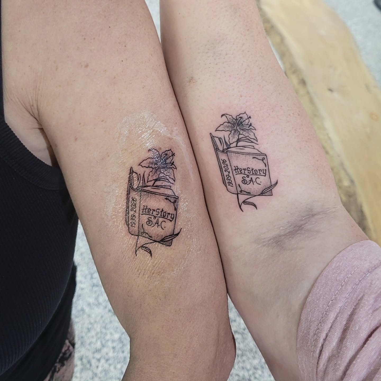 Book and plant black and grey tattoo on the forearm by Sarah Alba