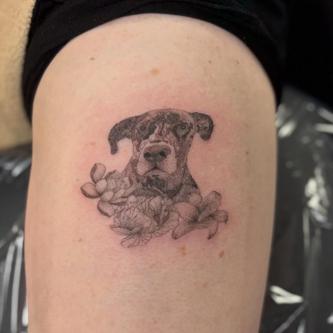 Dog portrait with flowers realism tattoo on the thigh by bradyn thornton: eco-tattoo artist