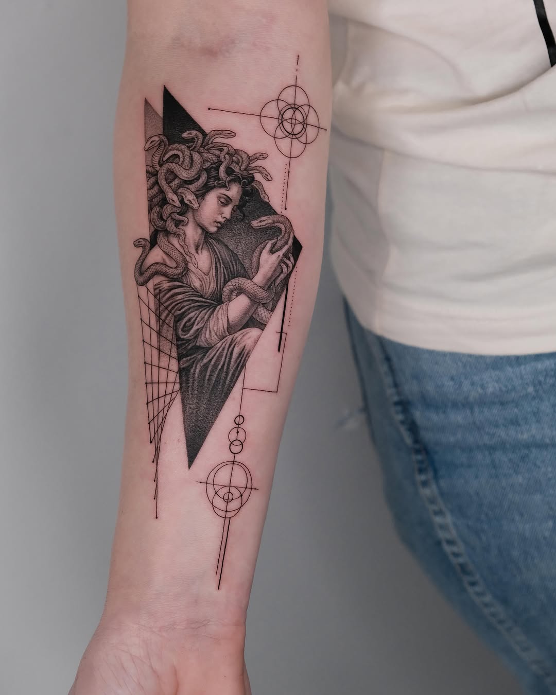 Medusa with snakes and geometric elements realism tattoo on the forearm by Zay - Realistic tattoo Artist