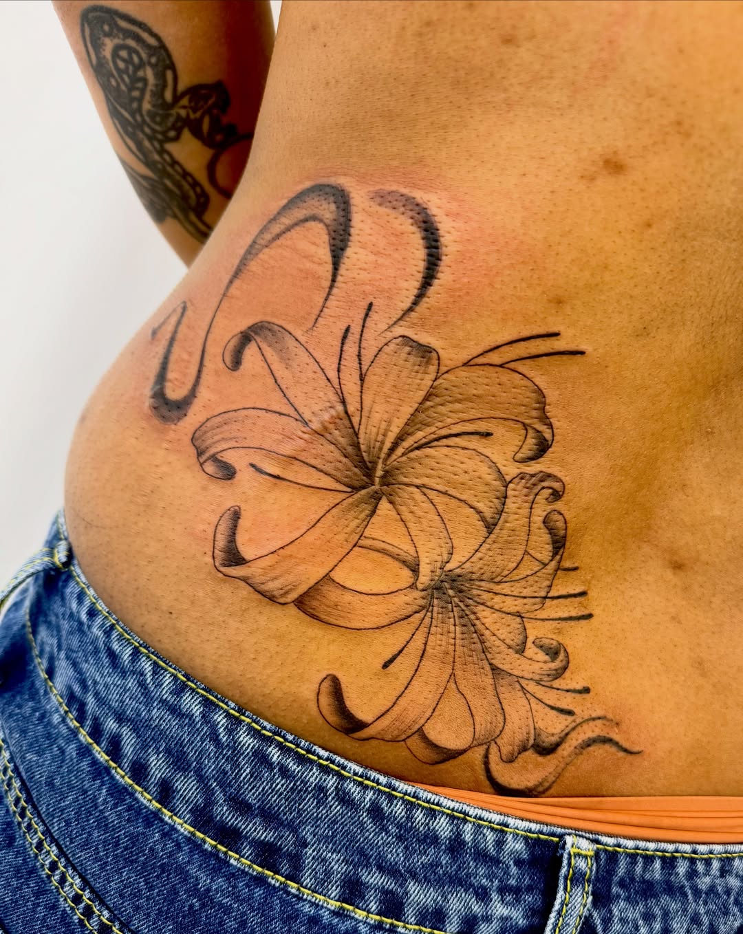 Flower black and grey tattoo on the torso by Jerry Thomas