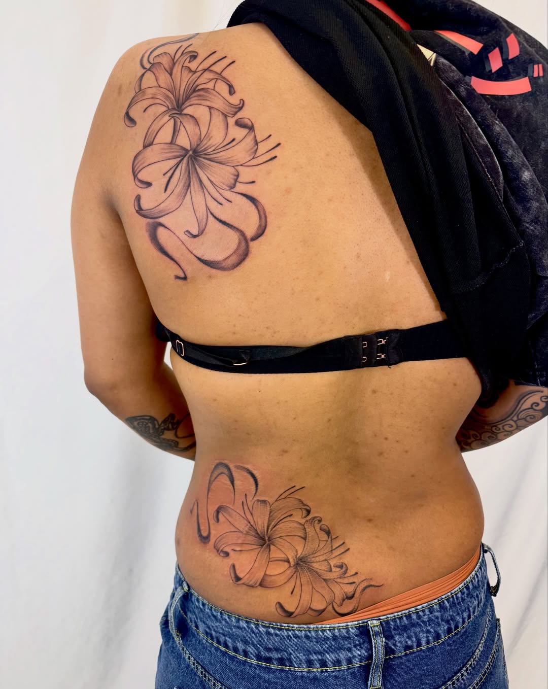 Lily black and grey tattoo on the back by Jerry Thomas