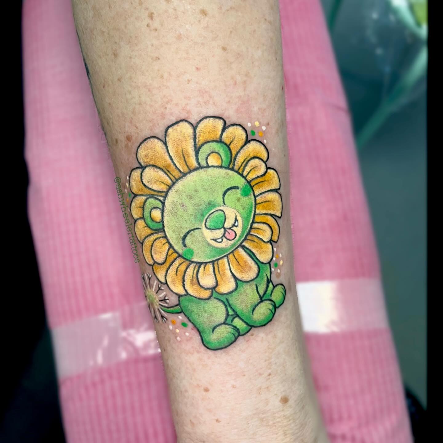 Lion new school tattoo on the forearm by Ash Wheeler