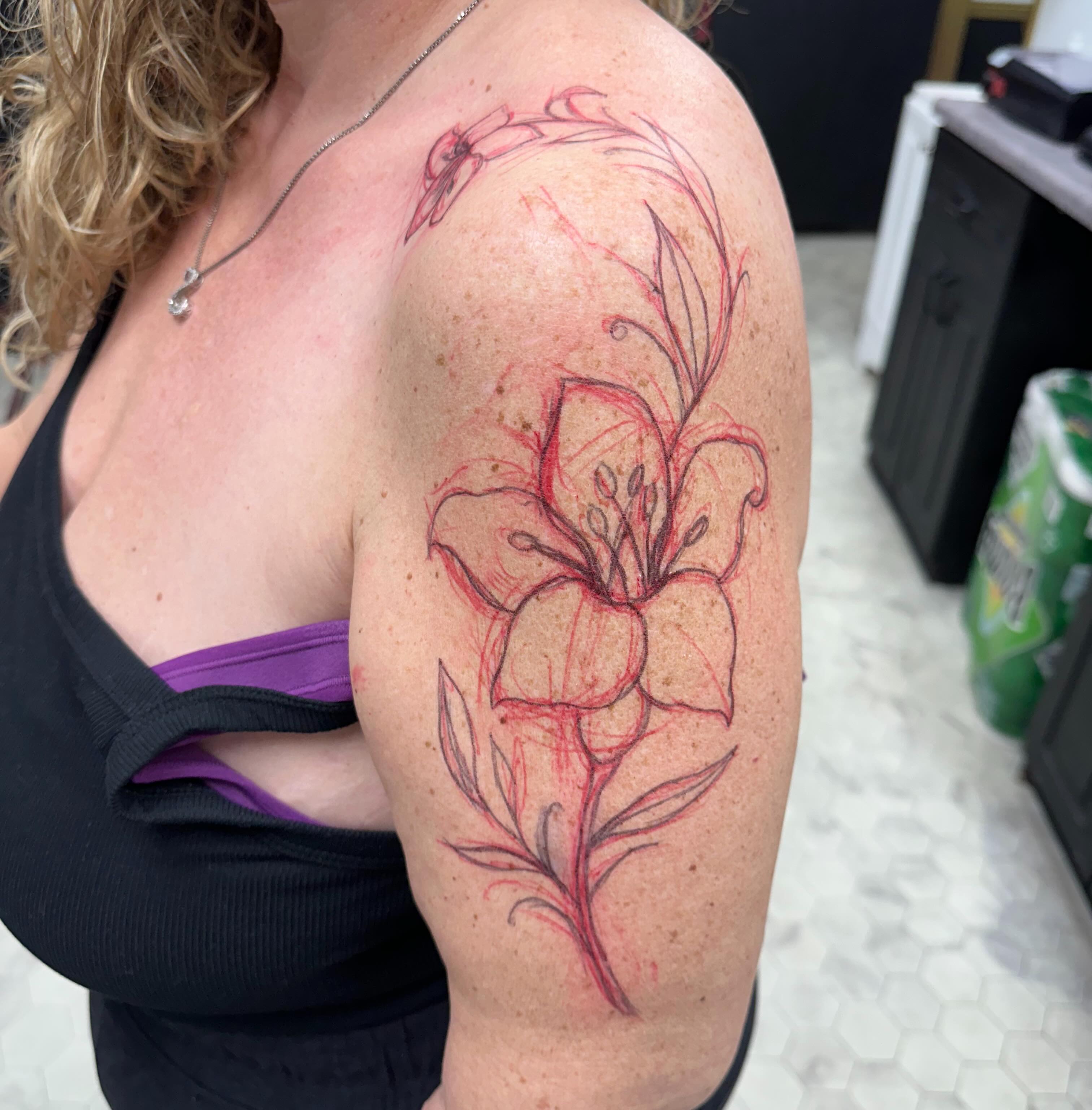 Lily fine line tattoo on the shoulder by Nicki Hoverson