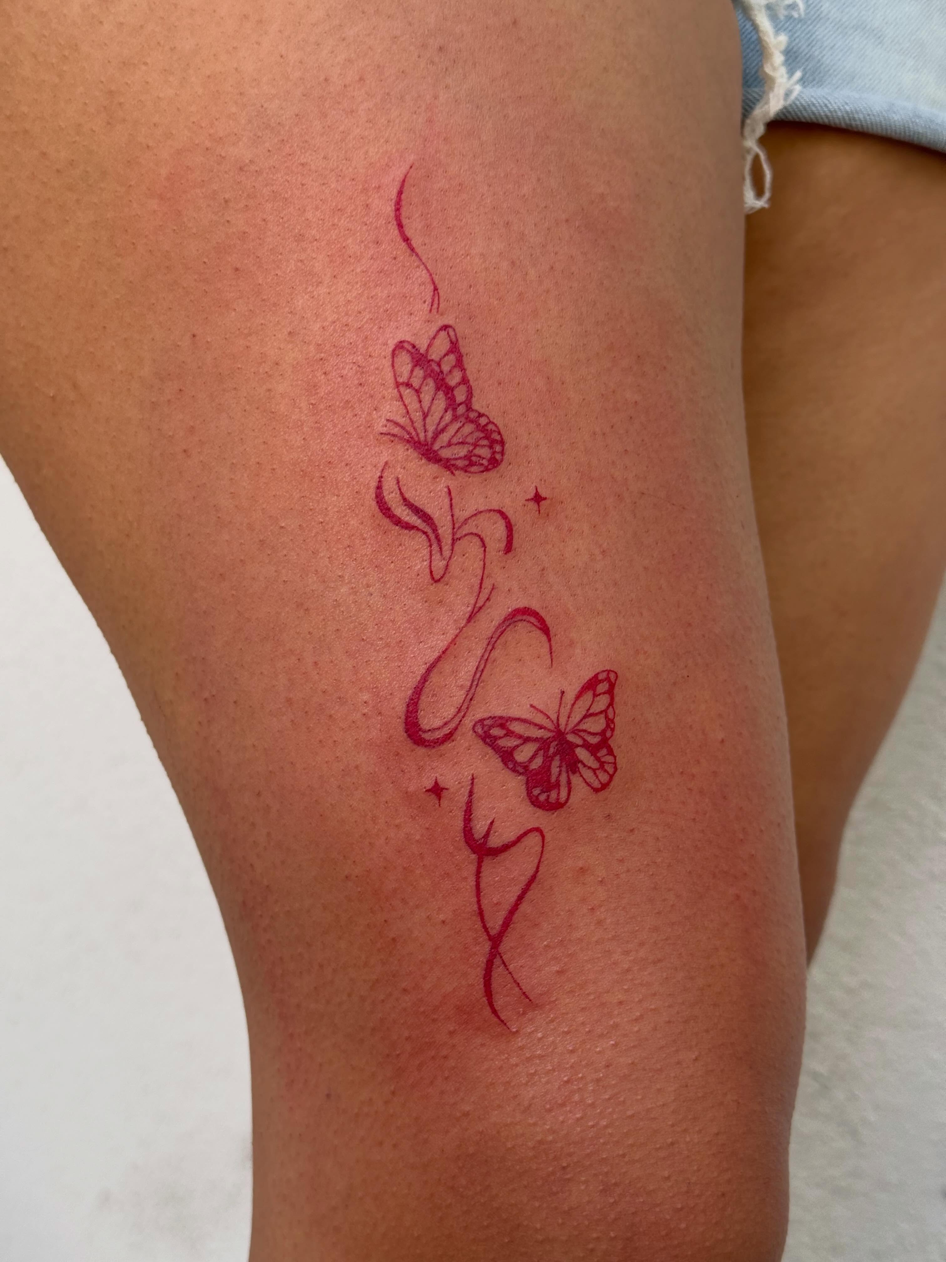 Butterflies fine line tattoo on the thigh by TATTOO & PIERCING ARTIST ₊˚⊹ ᰔ