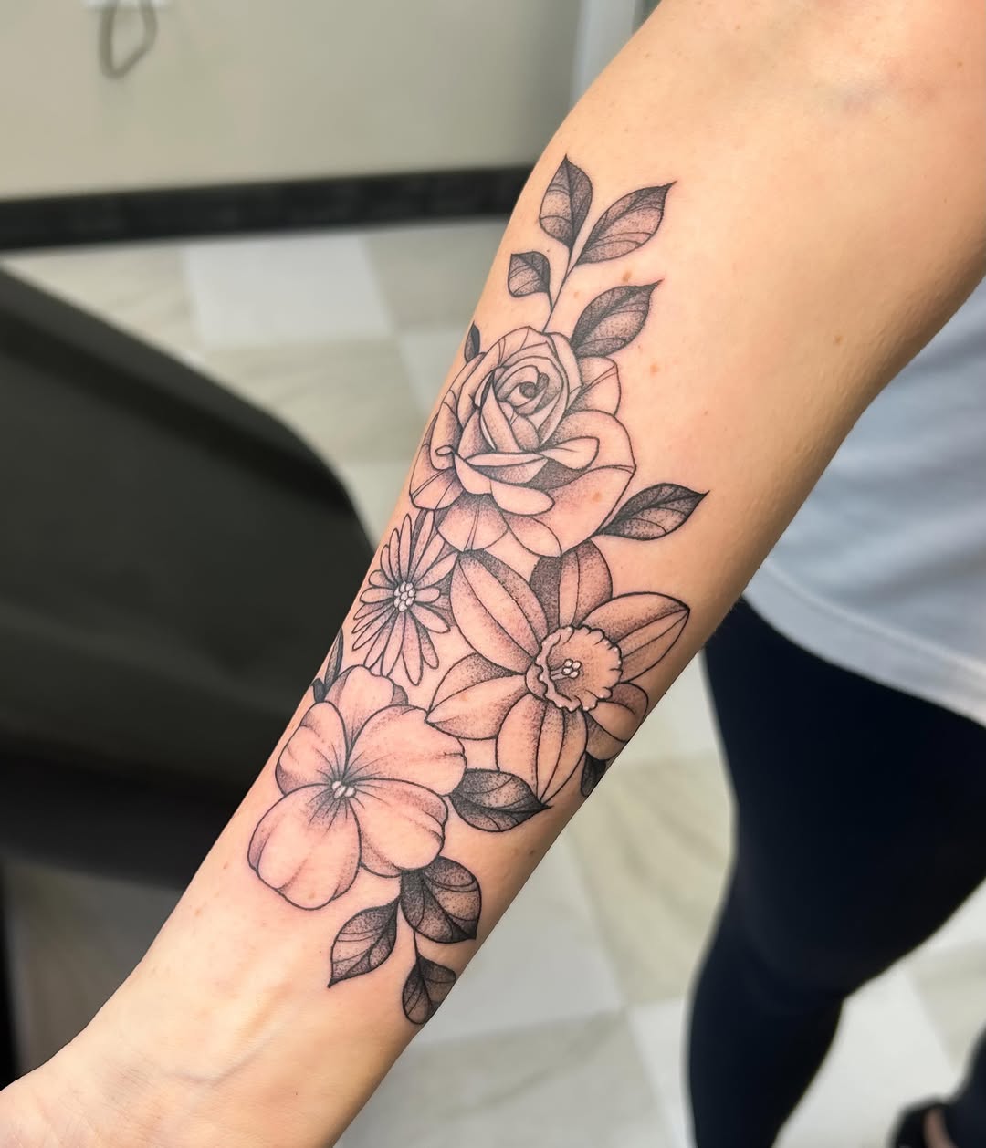 Floral arrangement dotwork tattoo on the forearm by kuna ink