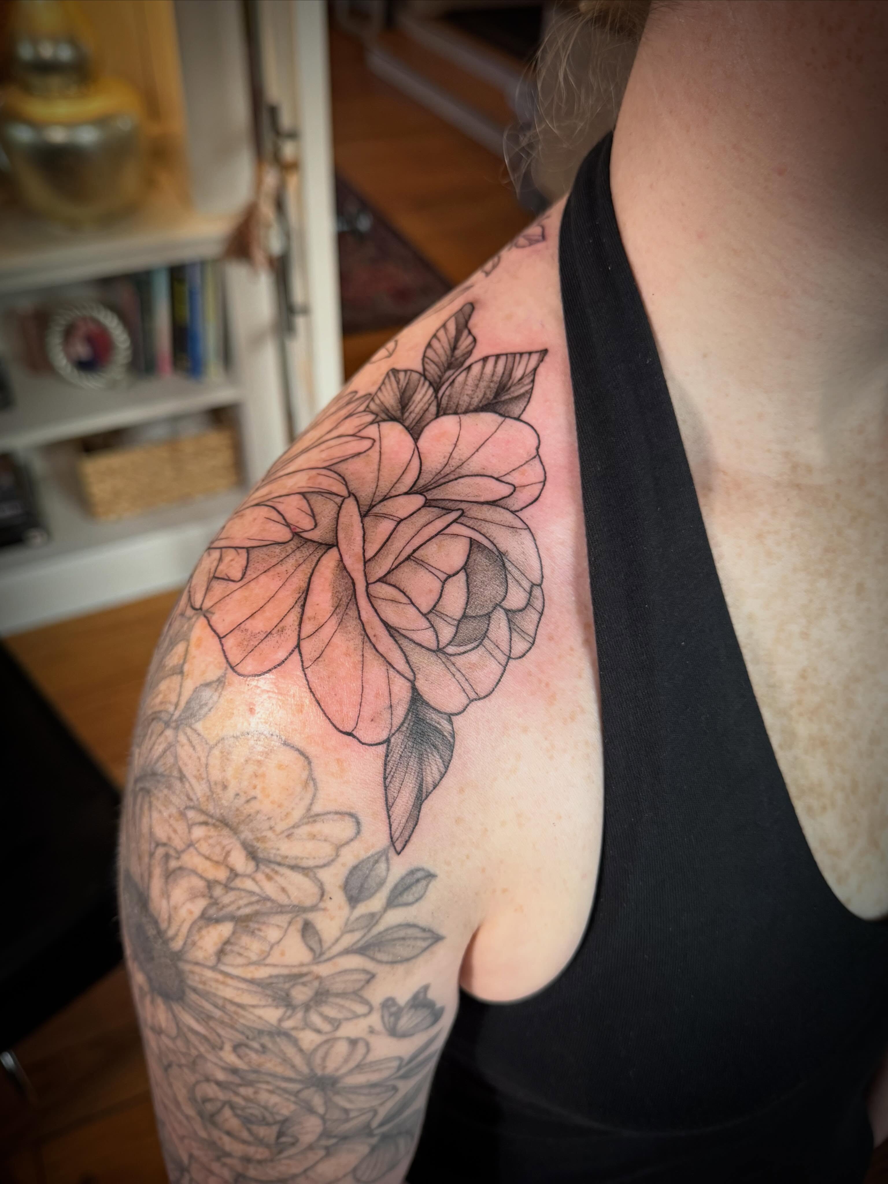 Flower black and grey tattoo on the shoulder by Tattoos by Alex
