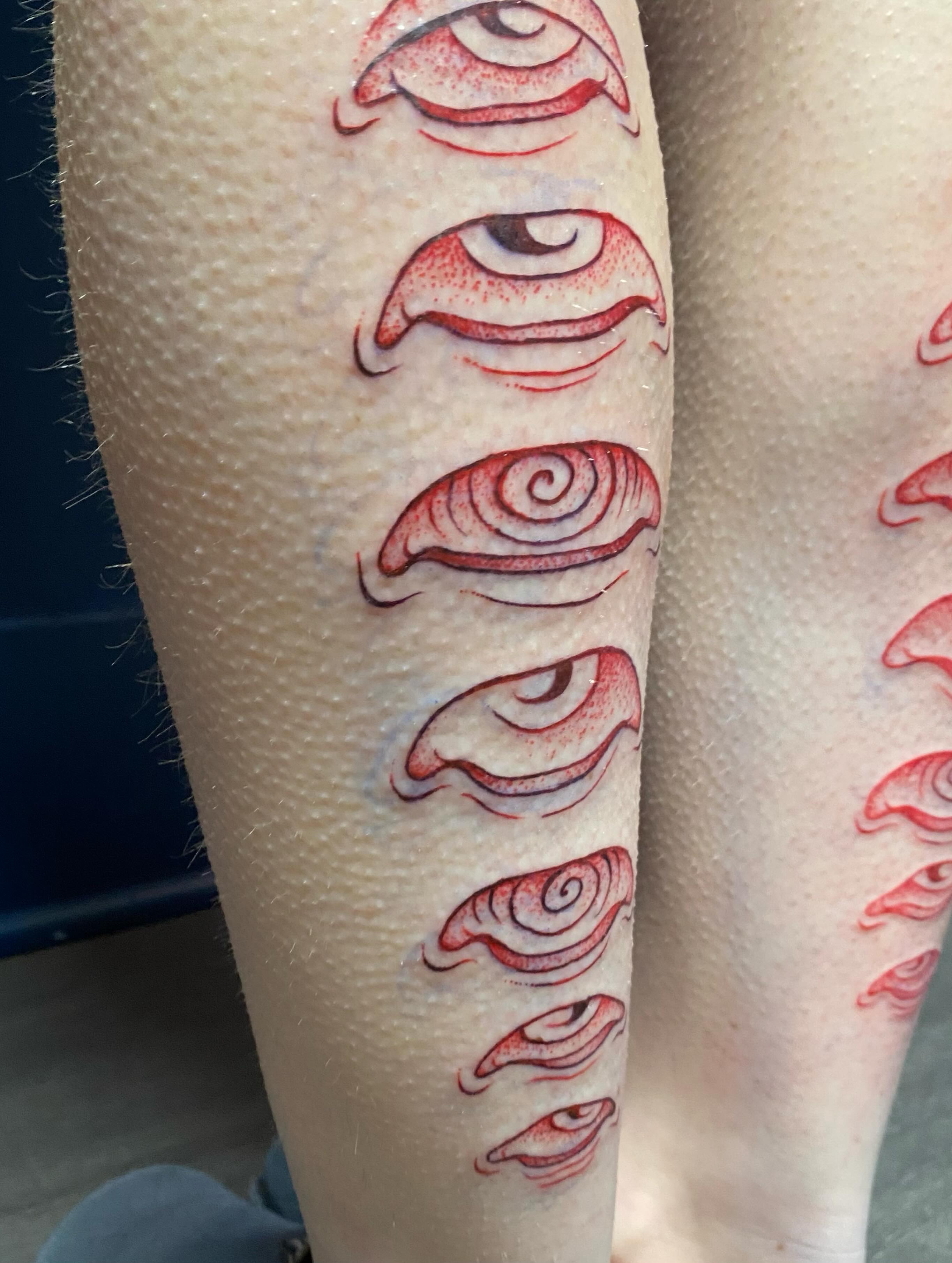 Eyes dotwork tattoo on the calf by Jesikah Rapp