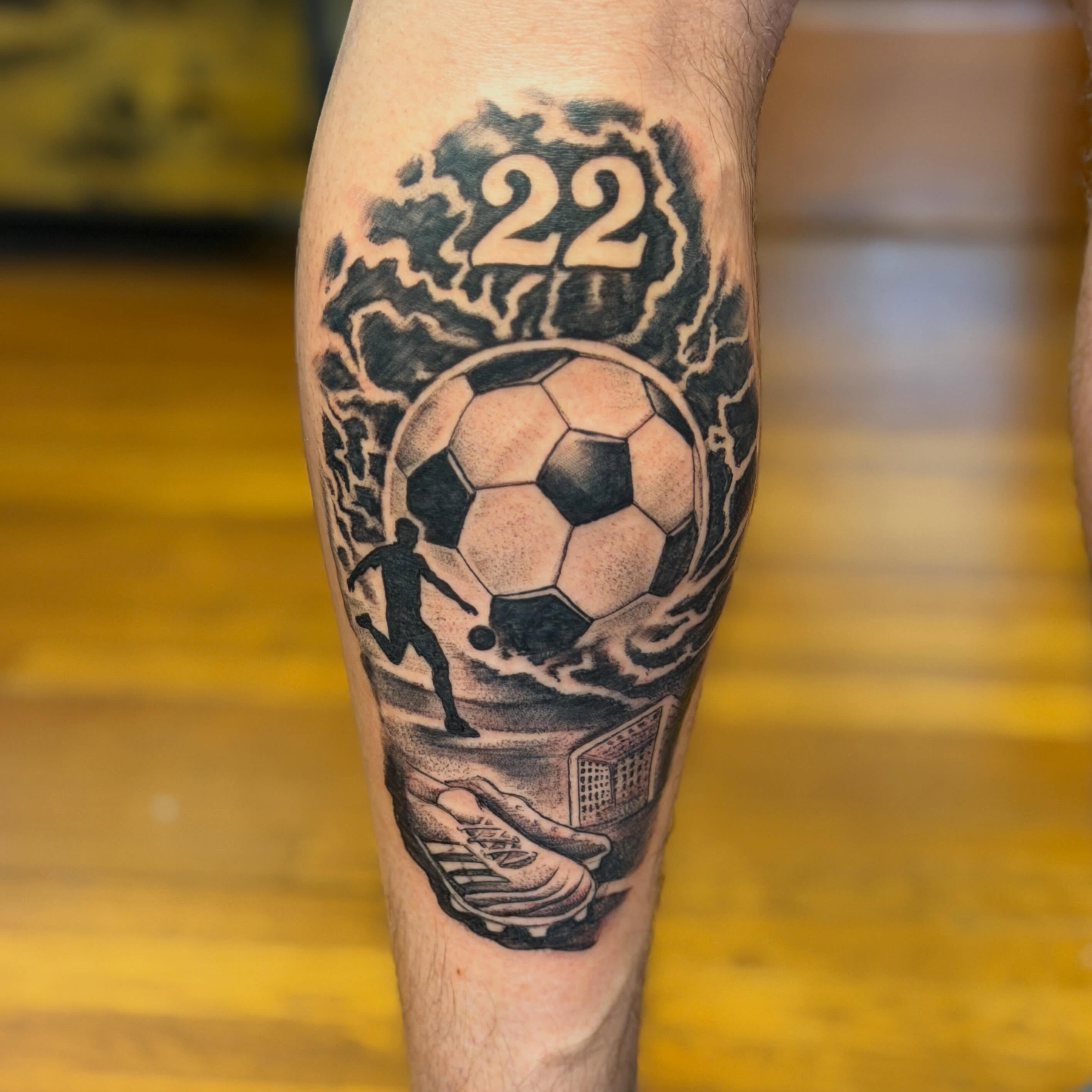 Soccer ball black and grey tattoo on the calf by Raul Najera Tattoo, Plano, Texas
