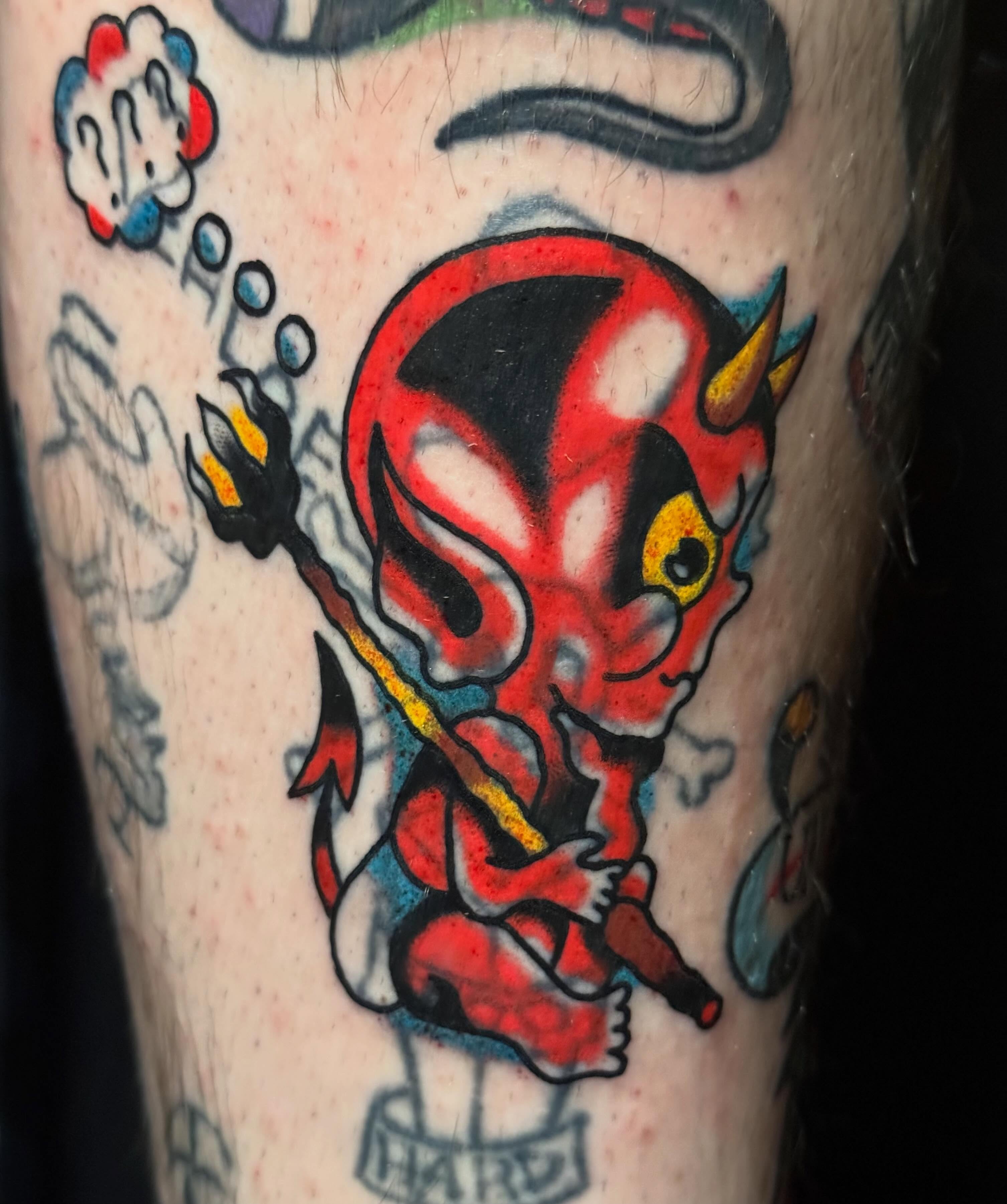 Red devil American traditional tattoo on the forearm by Zach Lemieux