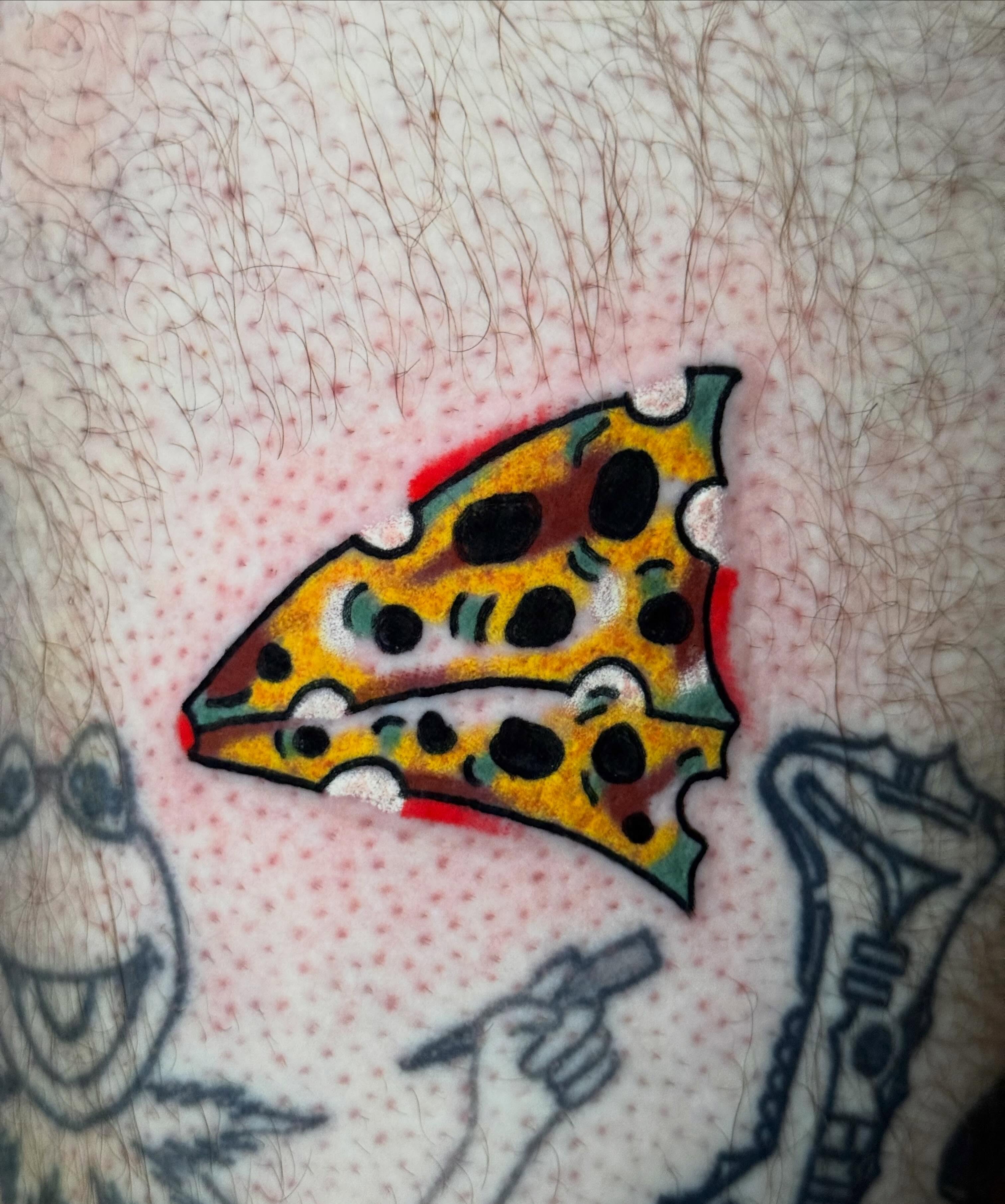 Pizza slice dotwork tattoo on the forearm by Zach Lemieux