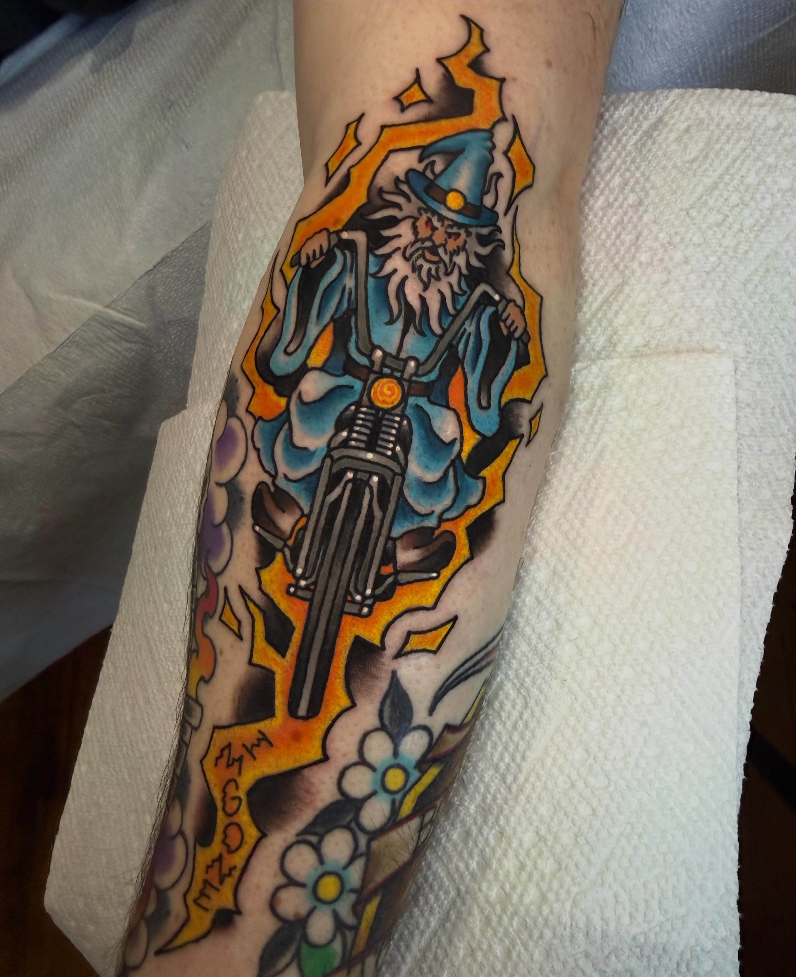 Wizard riding motorcycle American traditional tattoo on the forearm by Kyle Behr