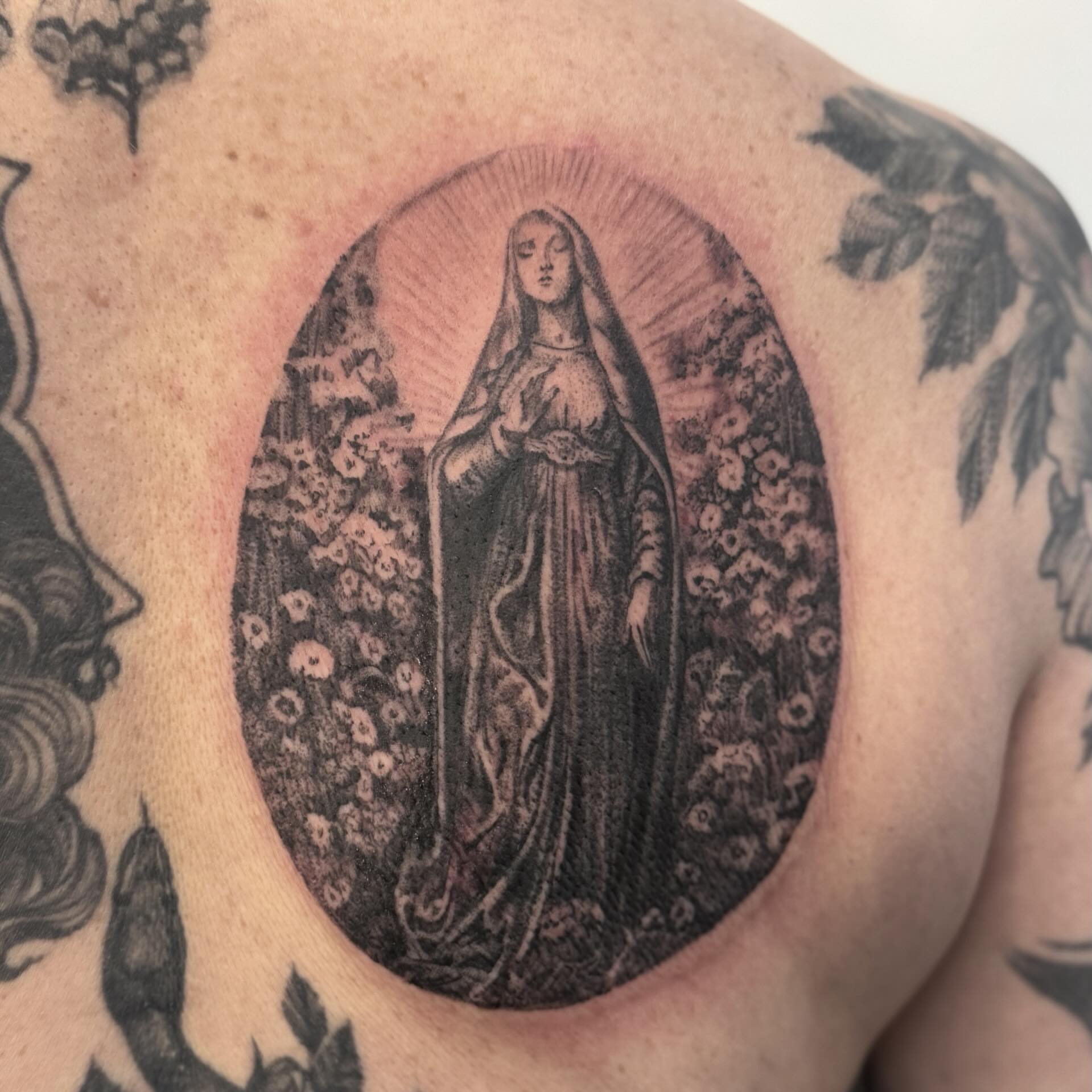 Virgin mary black and grey tattoo on the chest by Tianna Osborne