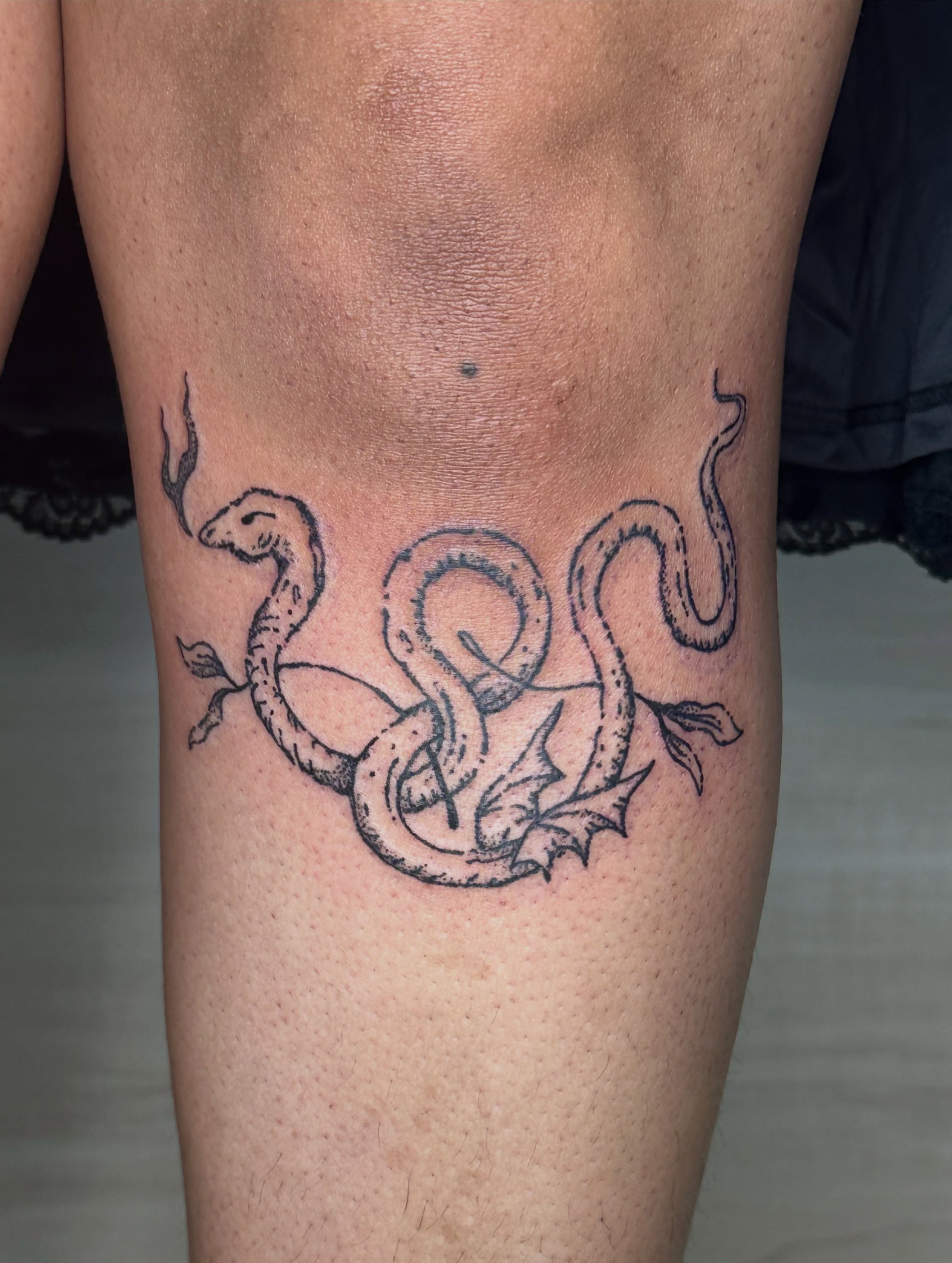 Snake and leaves black and grey tattoo on the thigh by Fleur ๐ฅ