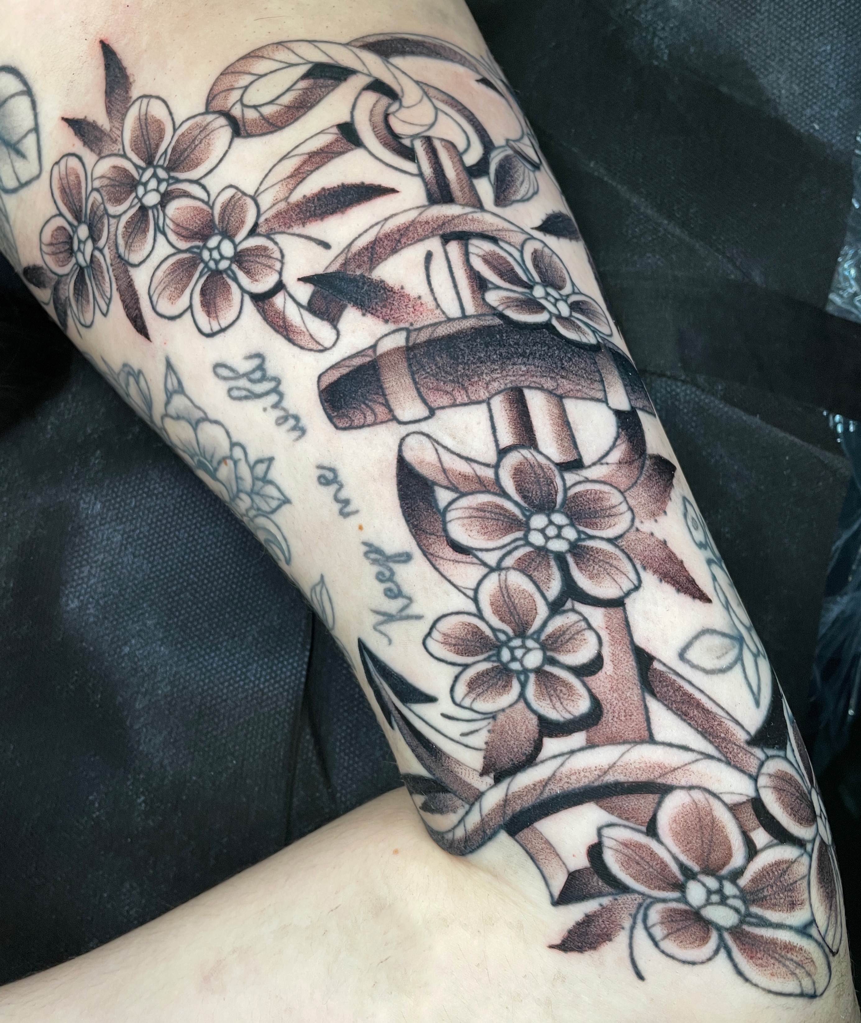 Anchor and flowers American traditional tattoo on the forearm by zoey sage ✦
