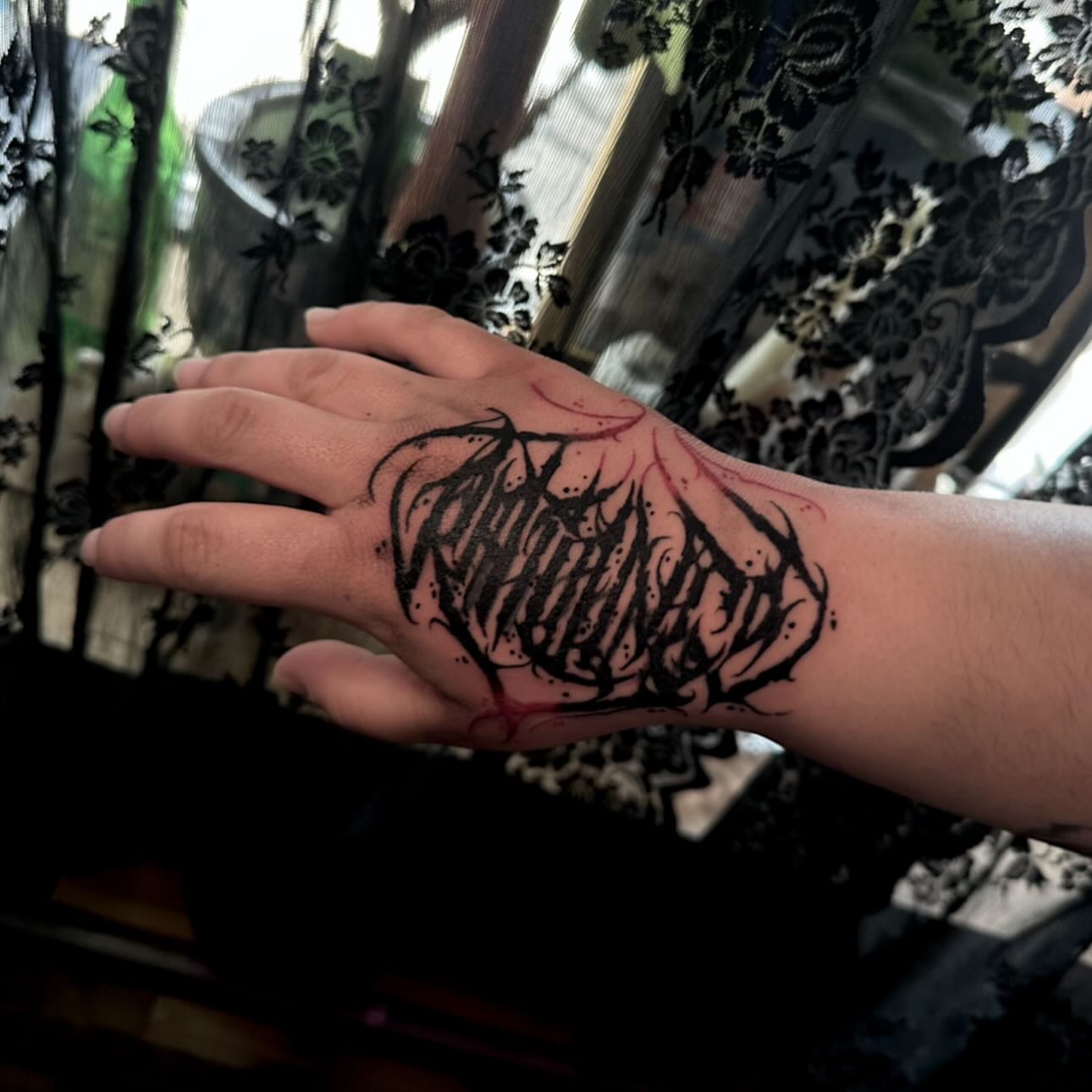 Lettering blackwork tattoo on the hand by Abigail Rae