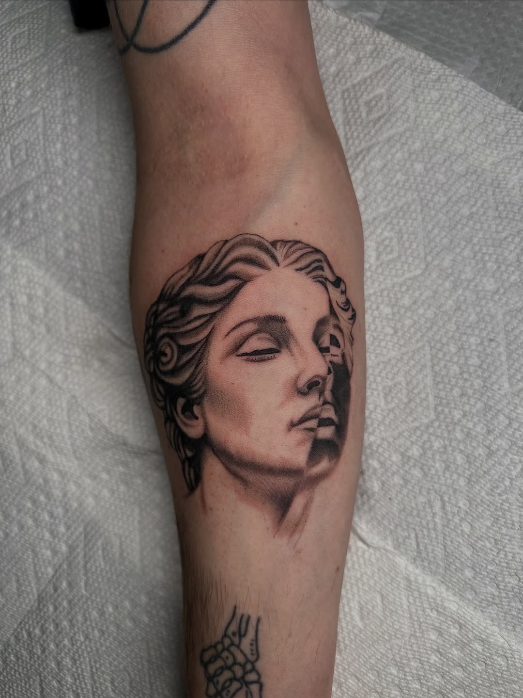 Classical sculpture portrait surrealism tattoo on the forearm by Tat by Brendan