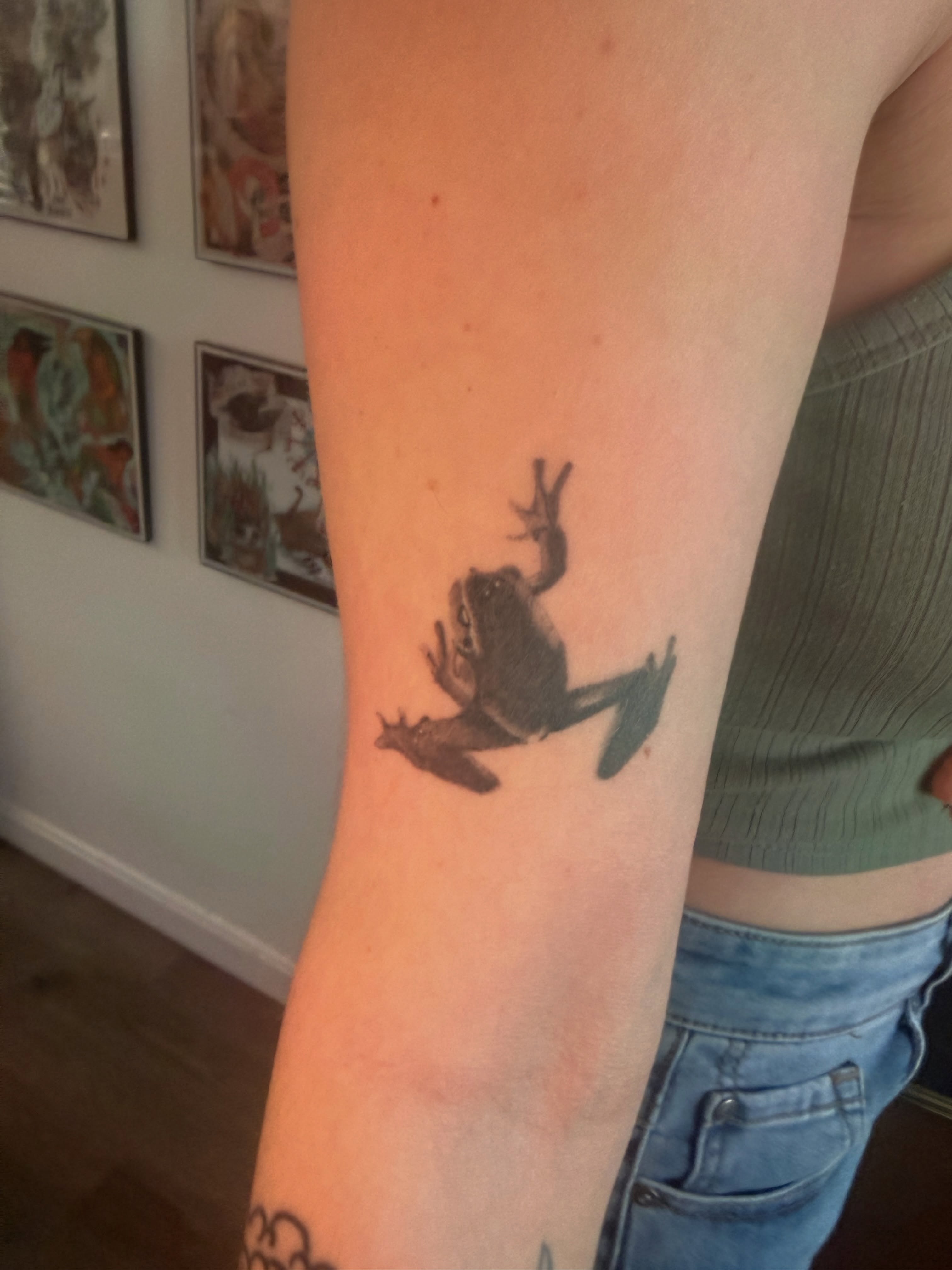 Frog black and grey tattoo on the forearm by Alaska
