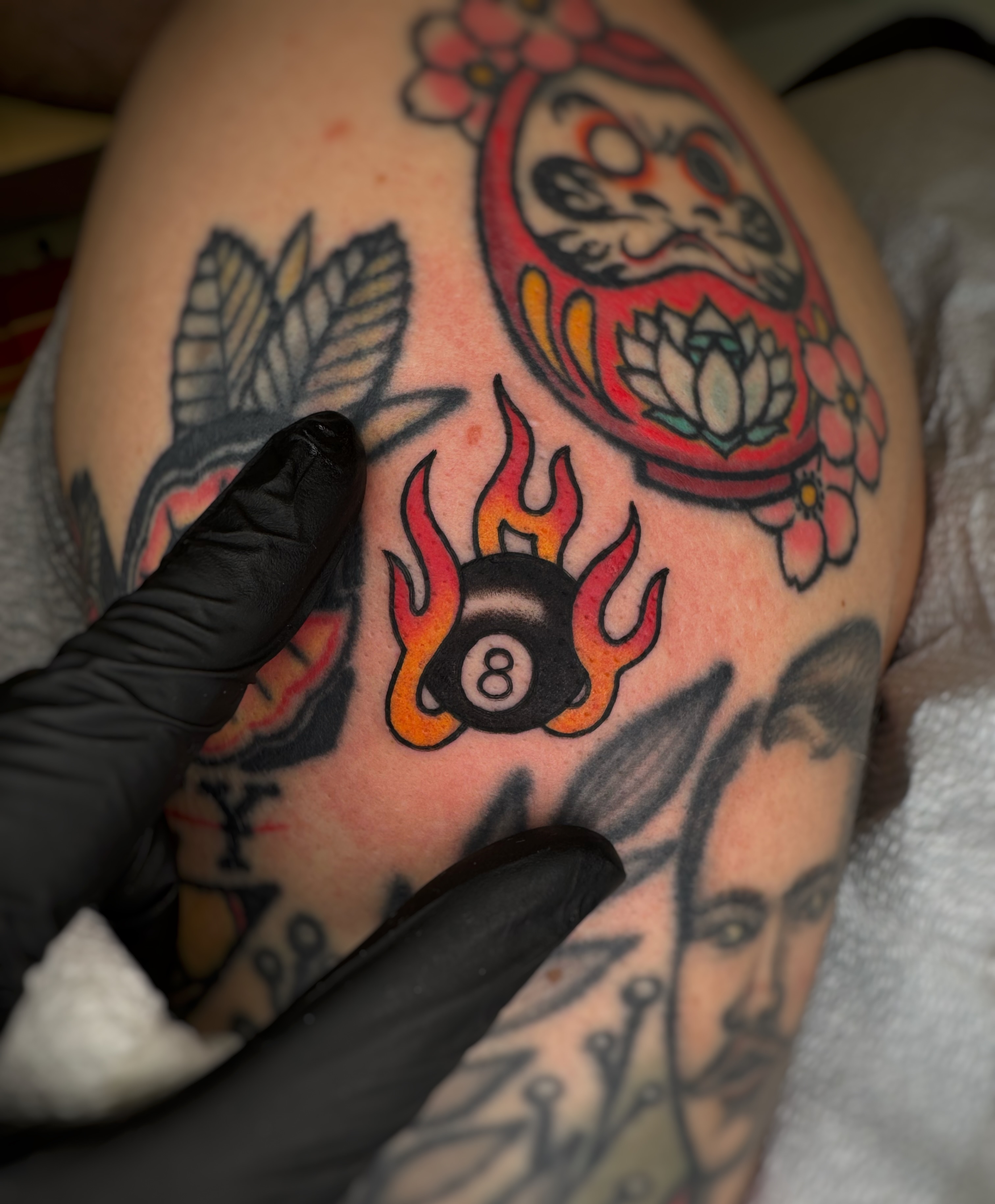 Flaming eight ball American traditional tattoo on the shoulder by Cori James Tattoo Artist