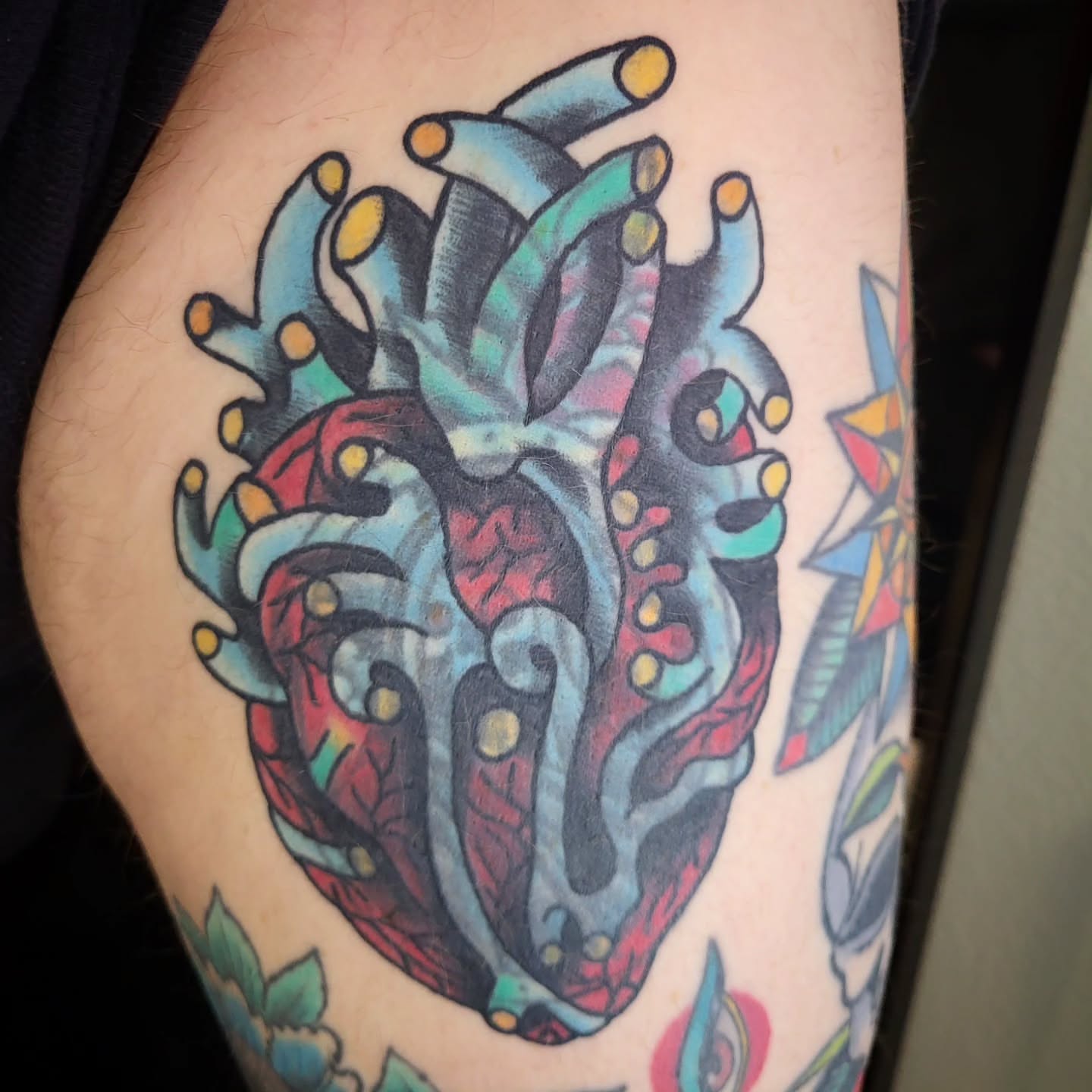 Anatomical heart American traditional tattoo on the thigh by Sloan Smith