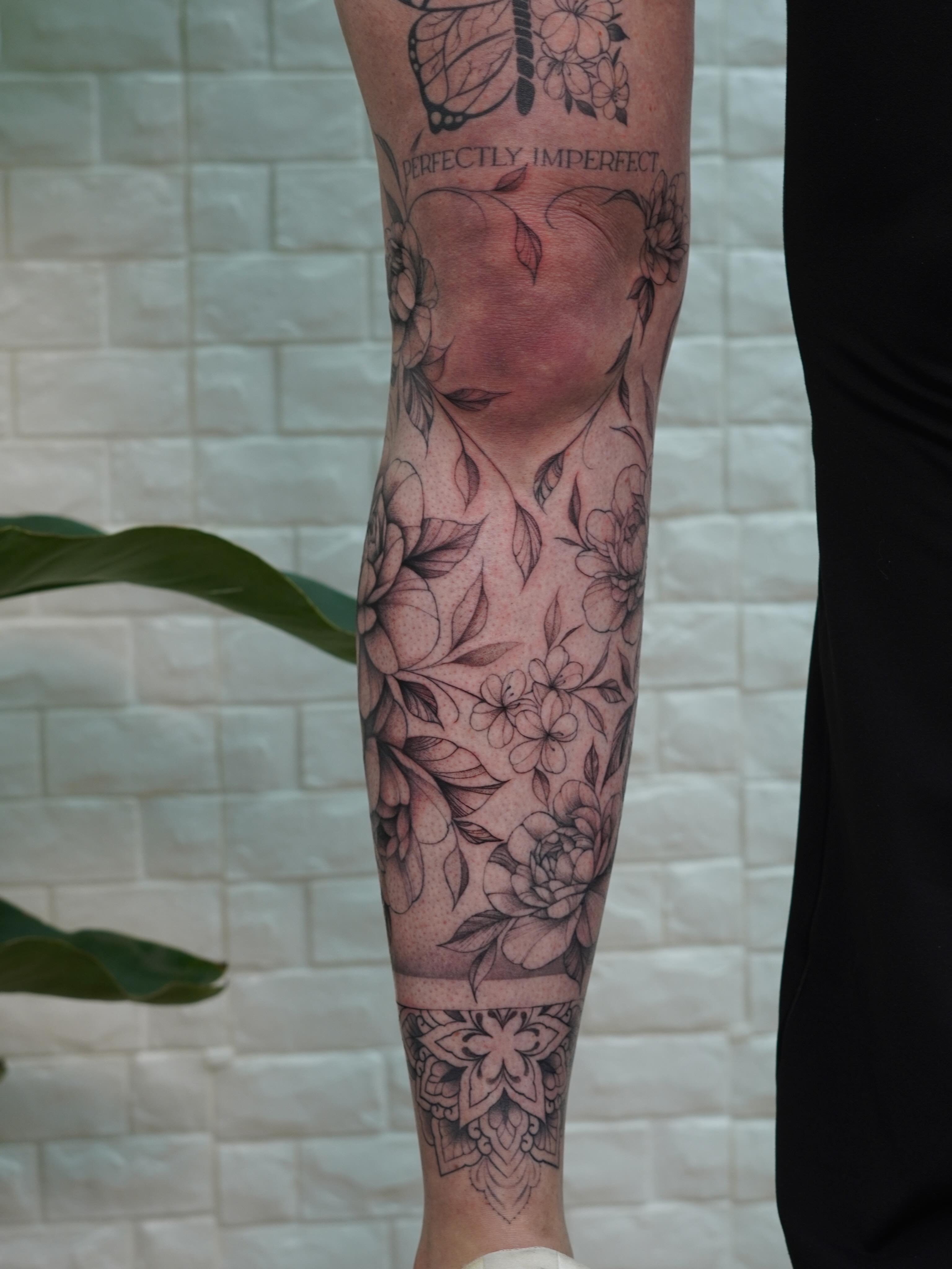 Floral bouquet realism tattoo on the calf by Danae Andino