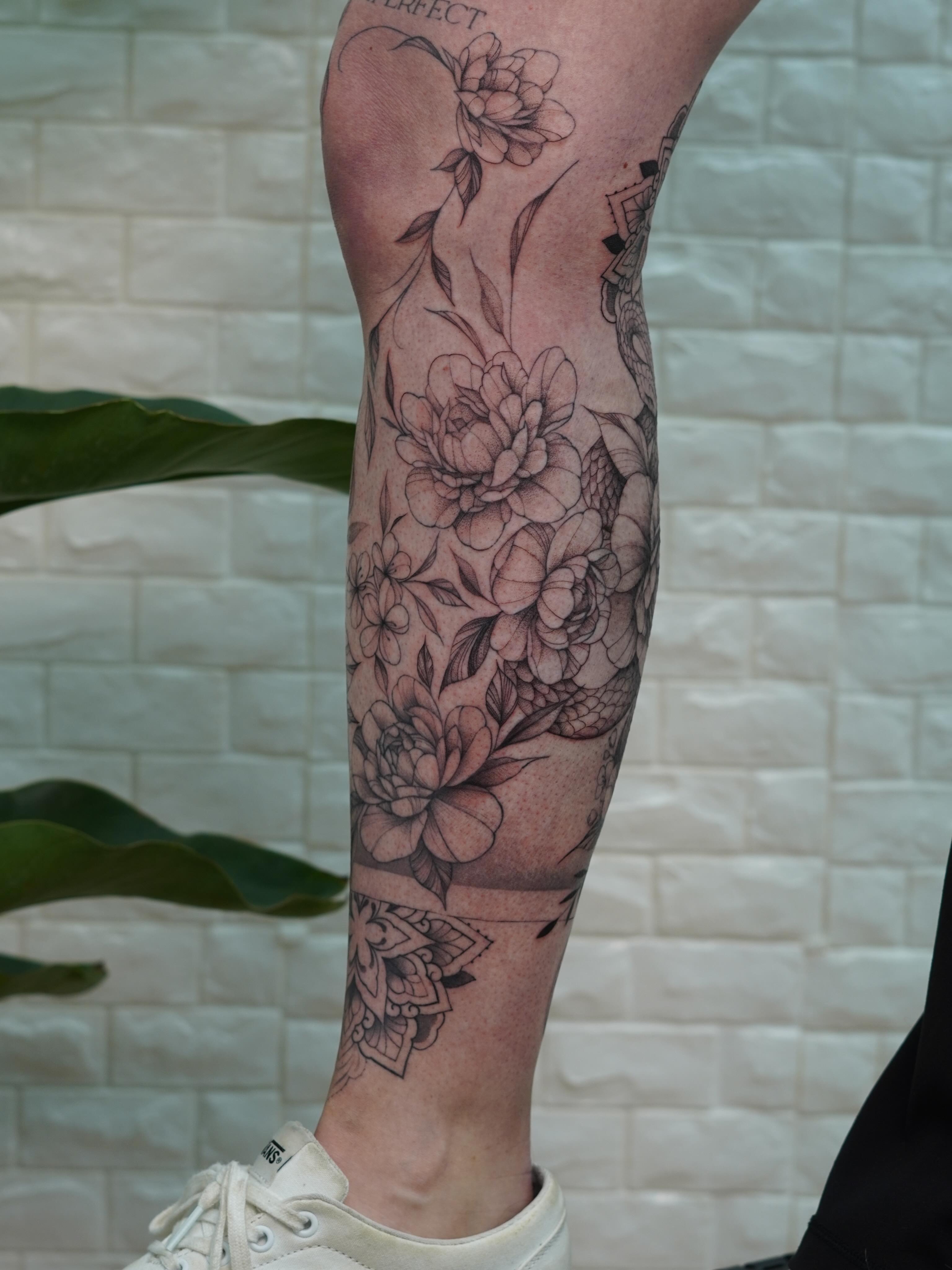 Floral bouquet black and grey tattoo on the calf by Danae Andino