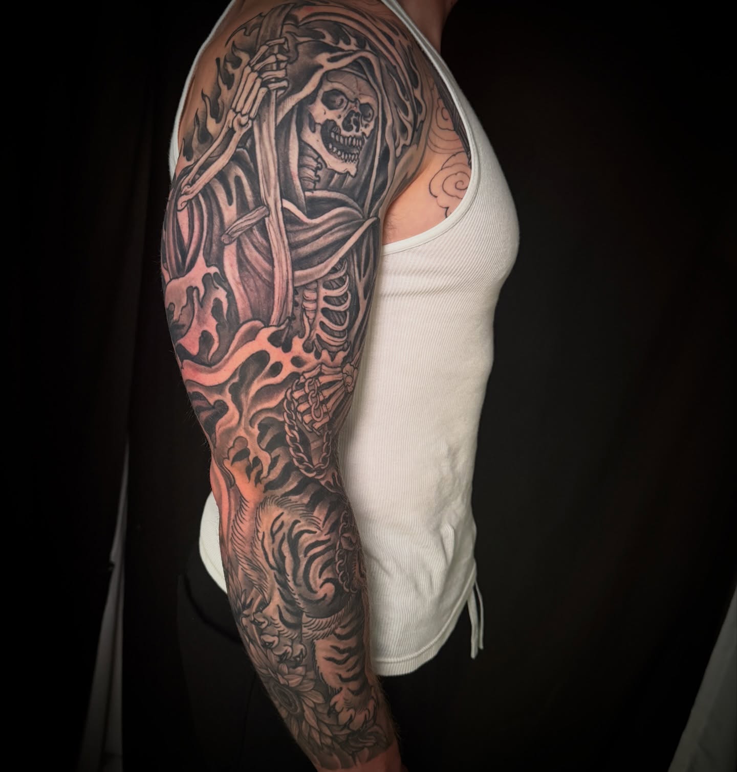 Grim reaper realism tattoo on the upper arm by Brian Hutflies