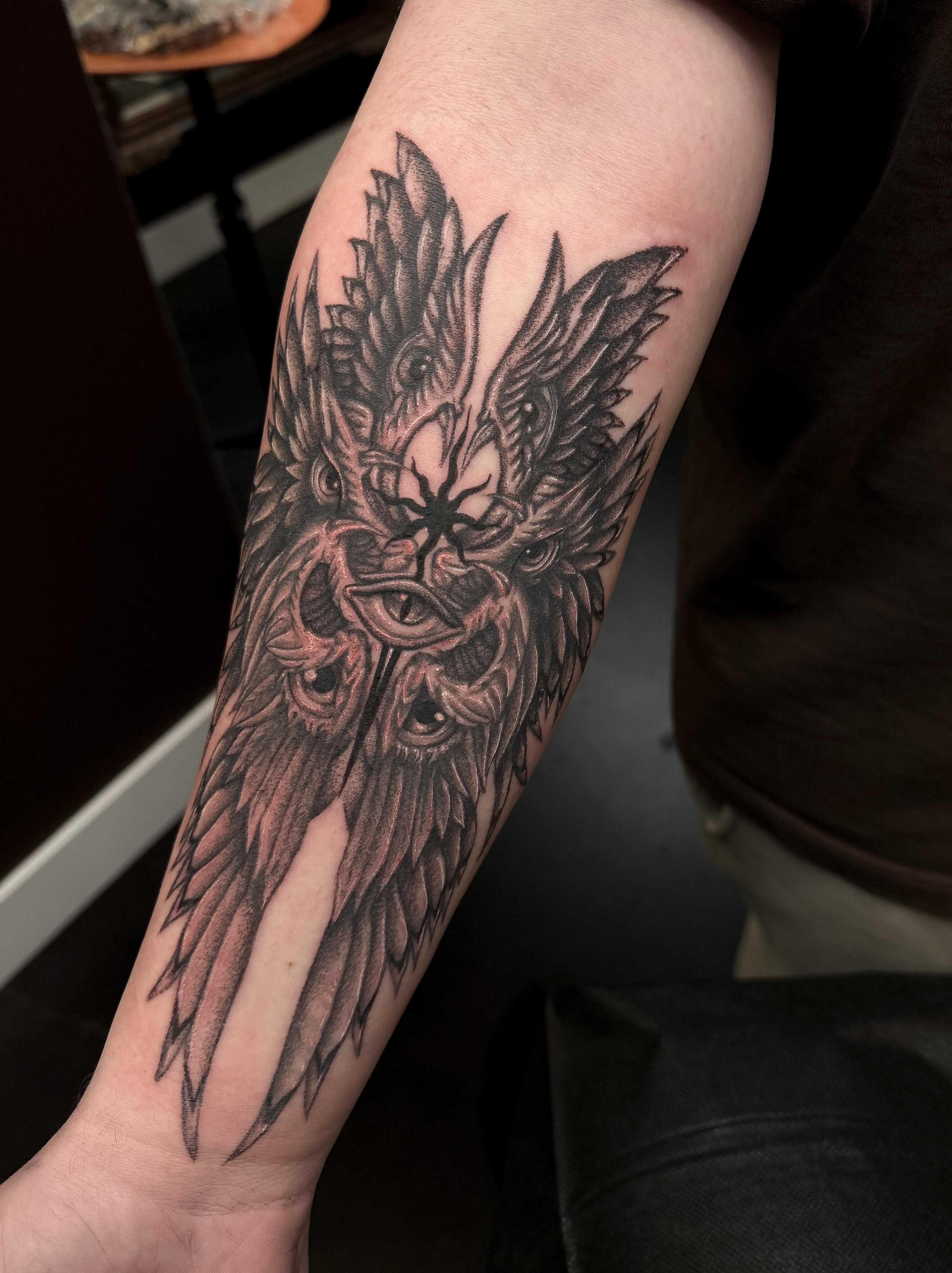 Owl black and grey tattoo on the forearm by Yvonne