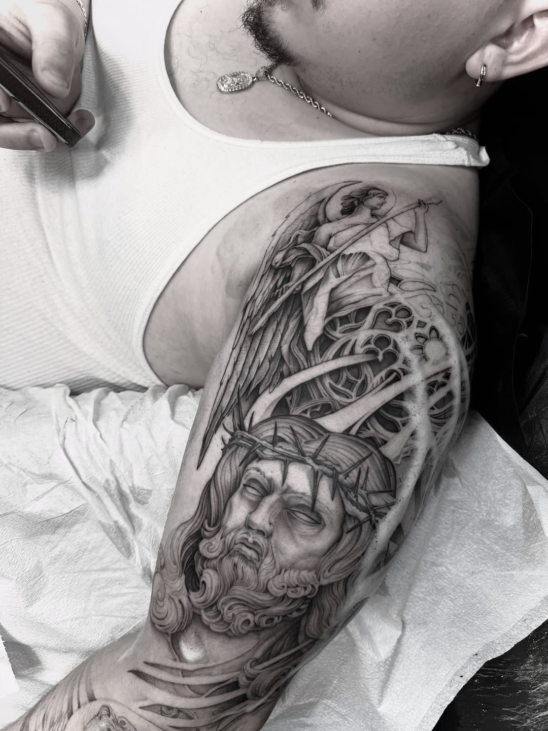 Jesus Christ and an angel realism tattoo on the shoulder by Steve Franciosa