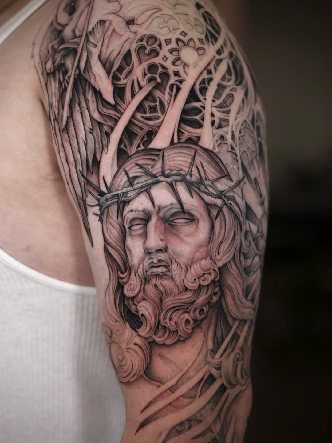 Jesus Christ with crown of thorns realism tattoo on the shoulder by Steve Franciosa