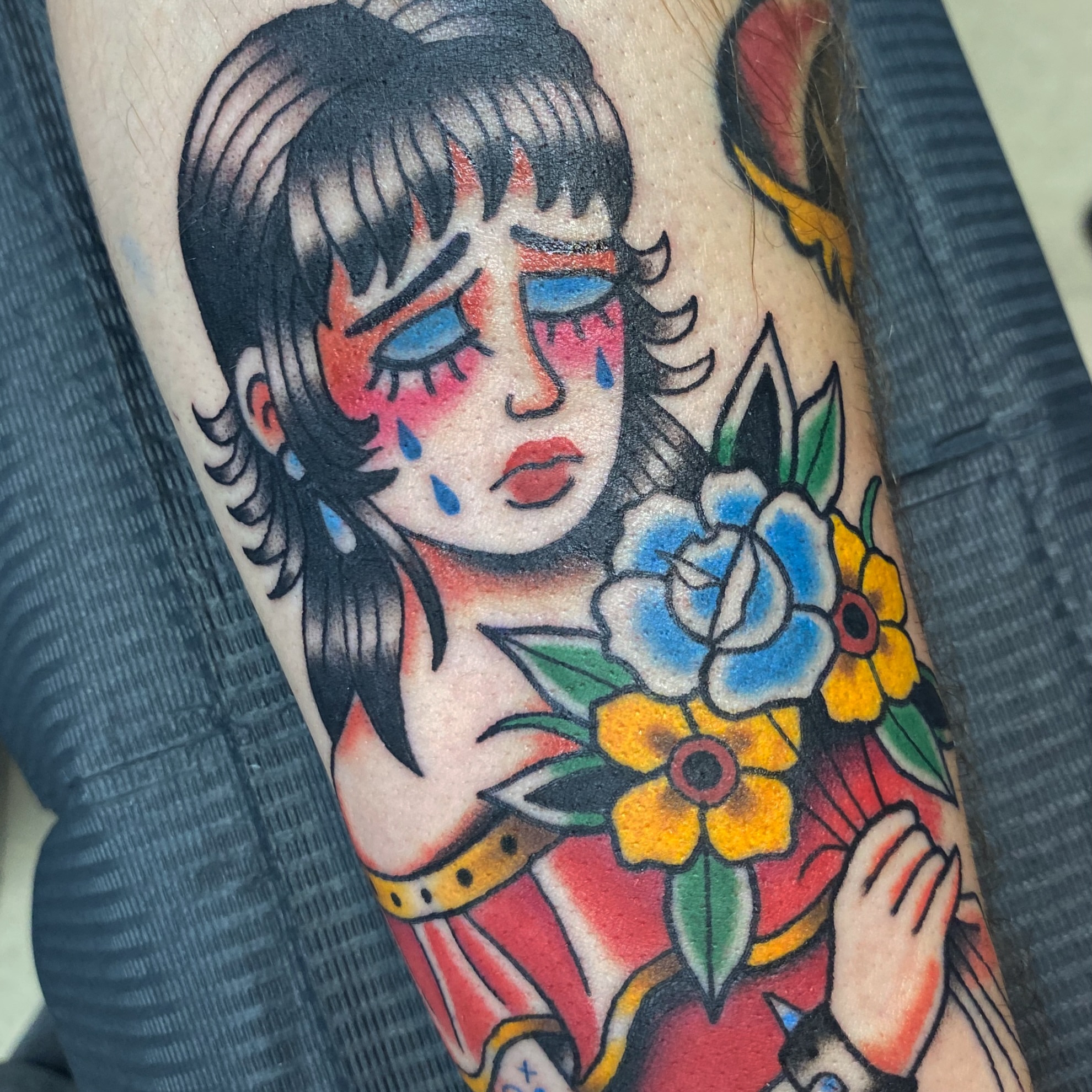 Geisha with flowers American traditional tattoo on the forearm by @katie_tatts