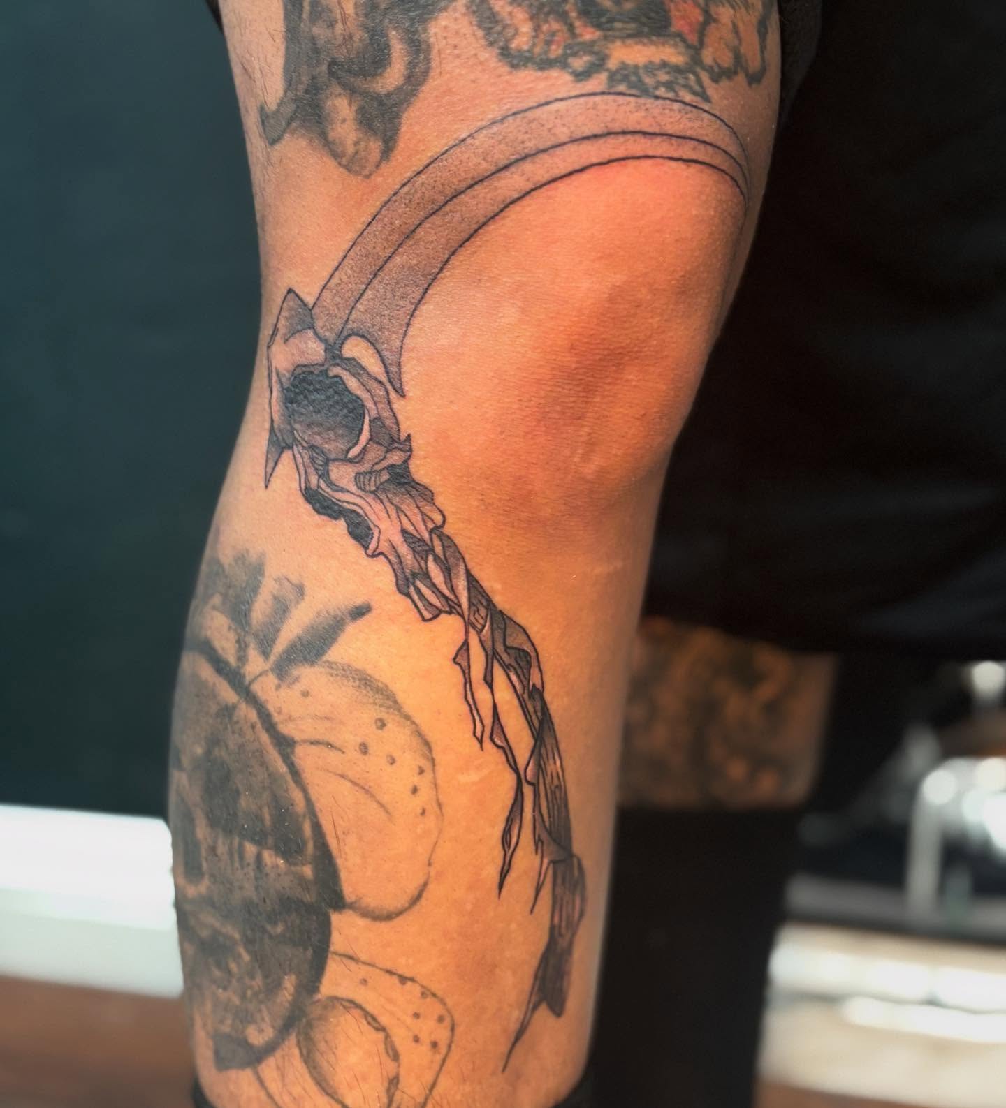 Skull and ribbon black and grey tattoo on the forearm by Emma ๐