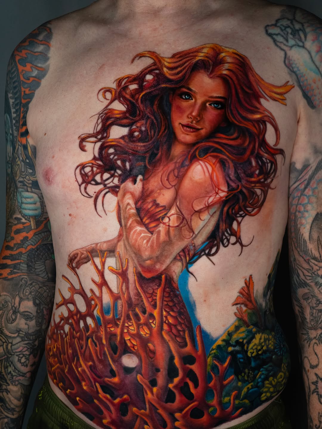 Mermaid and coral reef neo-traditional tattoo on the chest by Nate