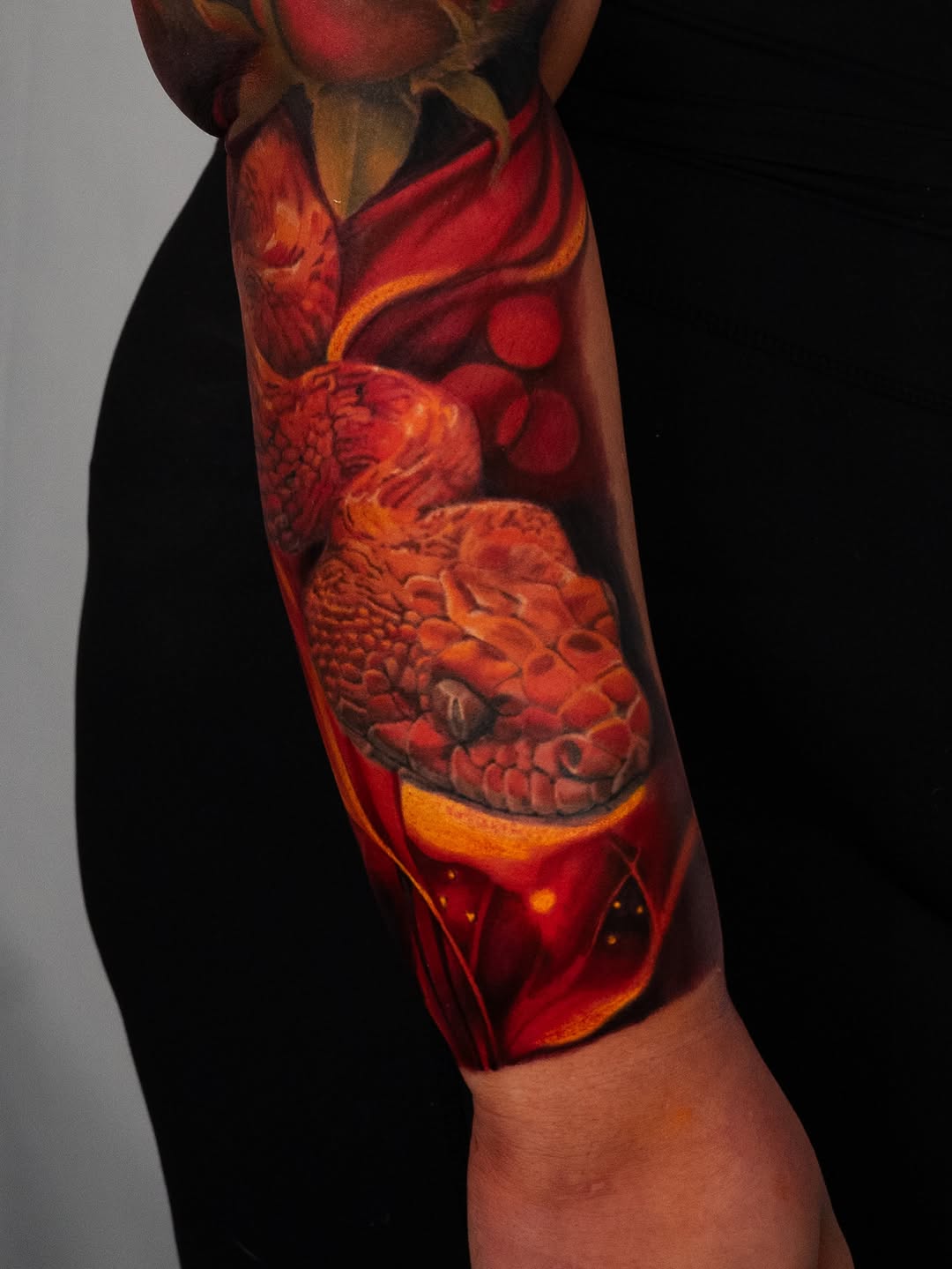 Snake head with flames realism tattoo on the forearm by Nate