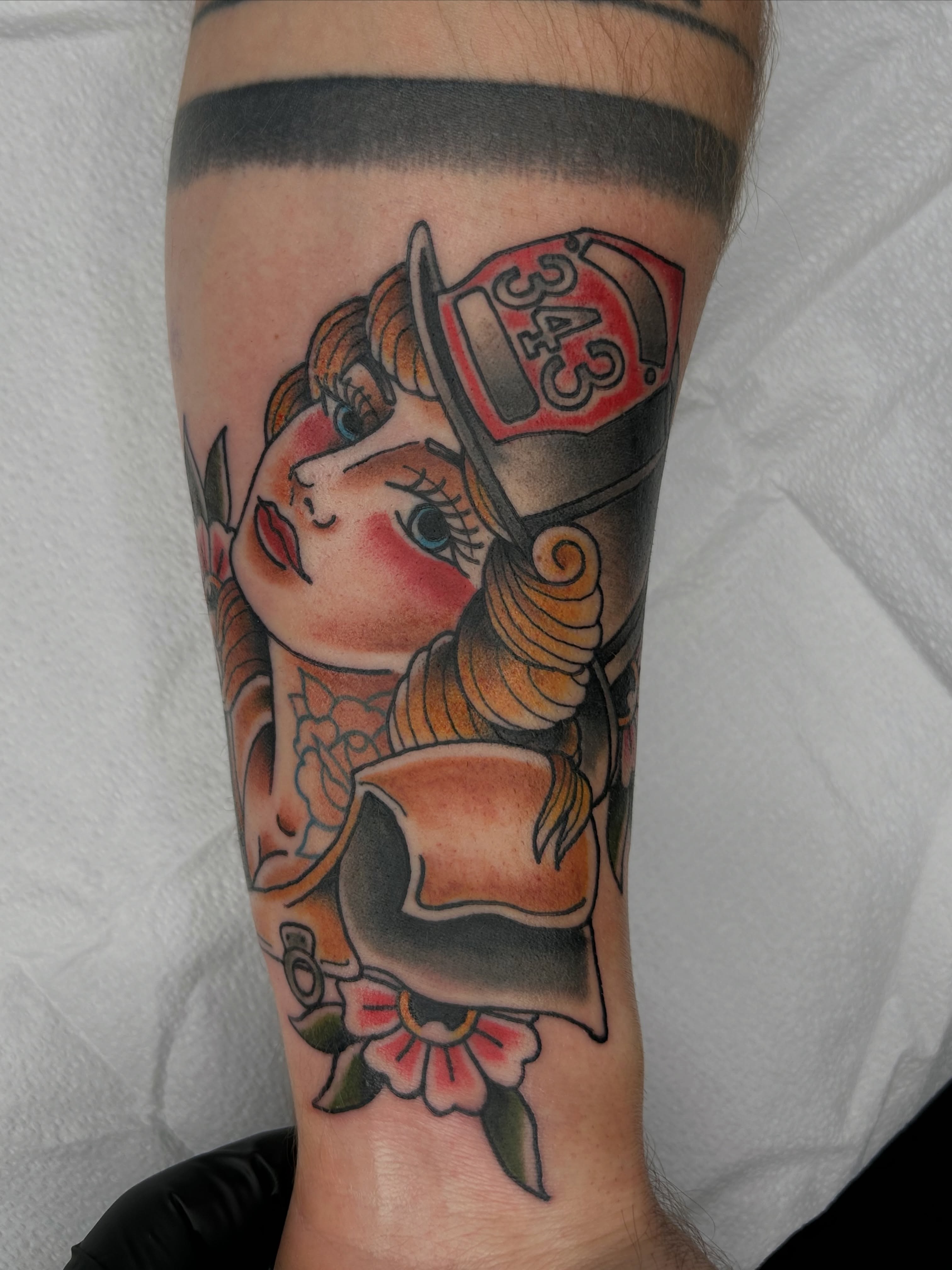 Firefighter girl American traditional tattoo on the forearm by Noah Crow