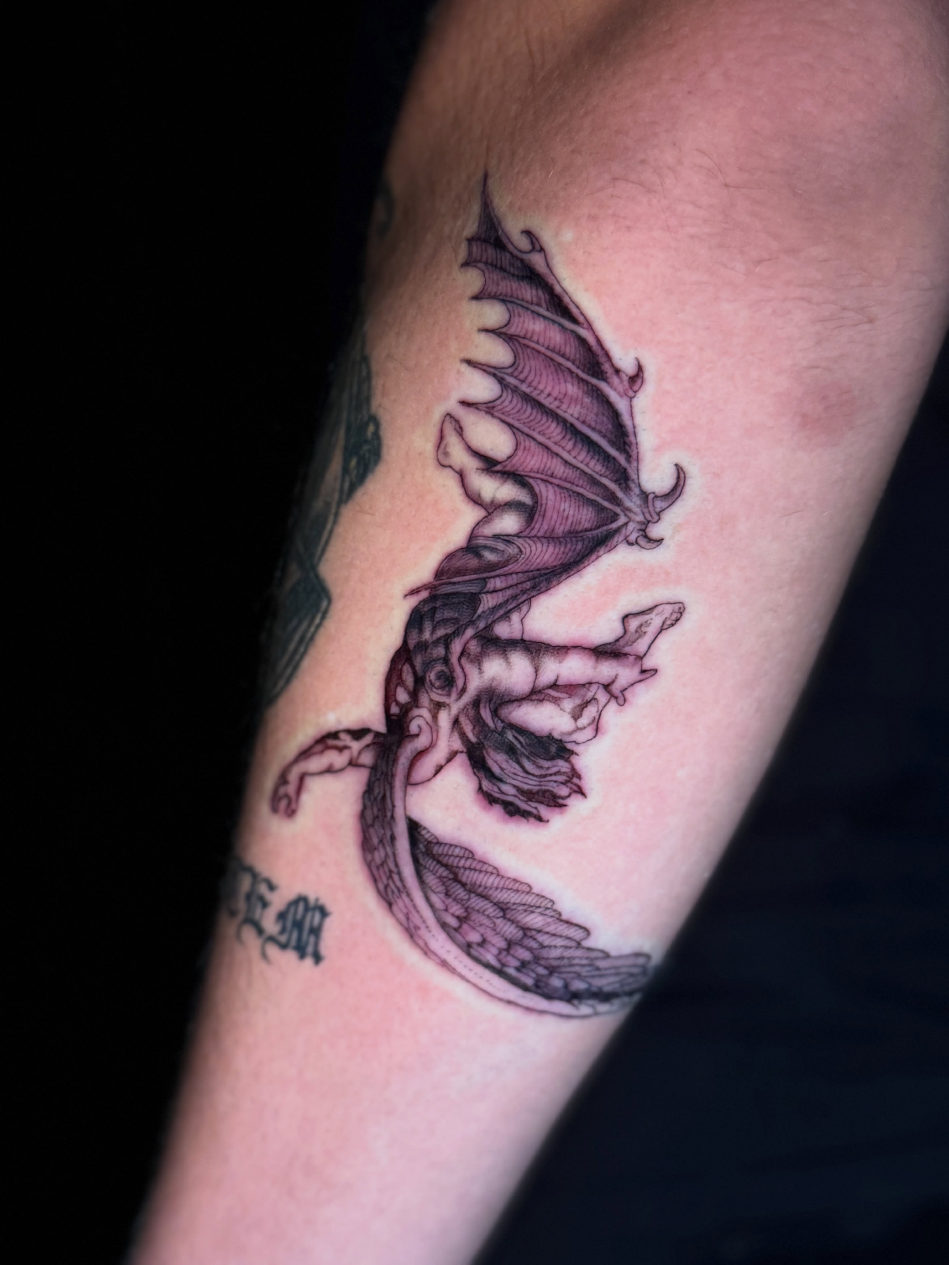 Dragon black and grey tattoo on the forearm by North County Sd