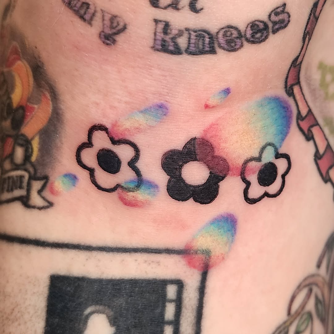 Flowers watercolor tattoo on the torso by Lindsey Andrew, Englewood, Colorado
