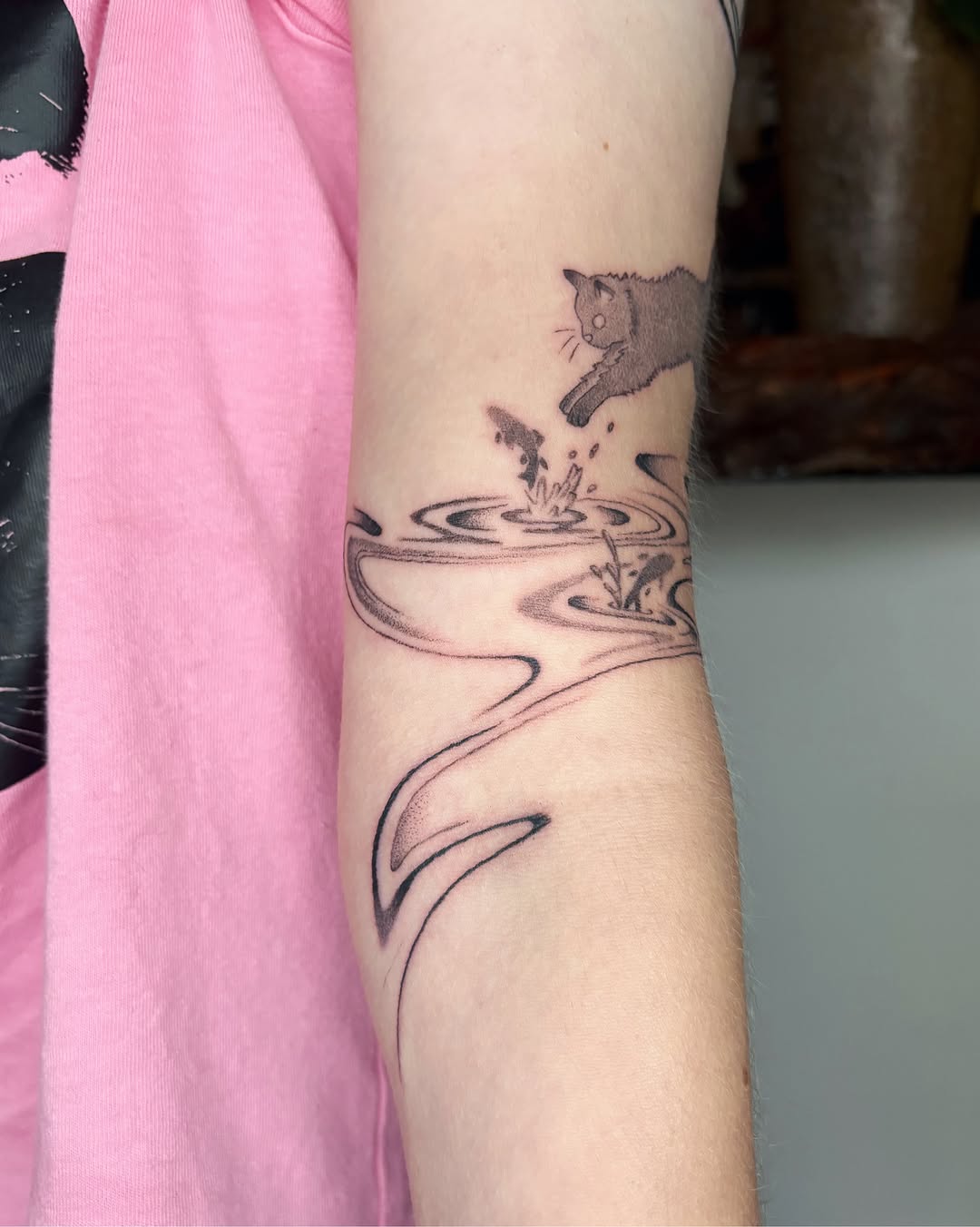 Cat jumping into water dotwork tattoo on the forearm by Abigail, San Francisco, California
