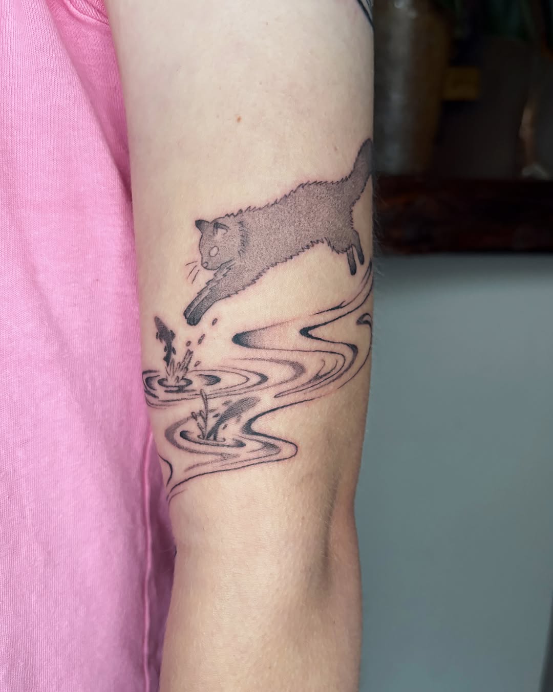 Cat jumping realism tattoo on the forearm by Abigail, San Francisco, California
