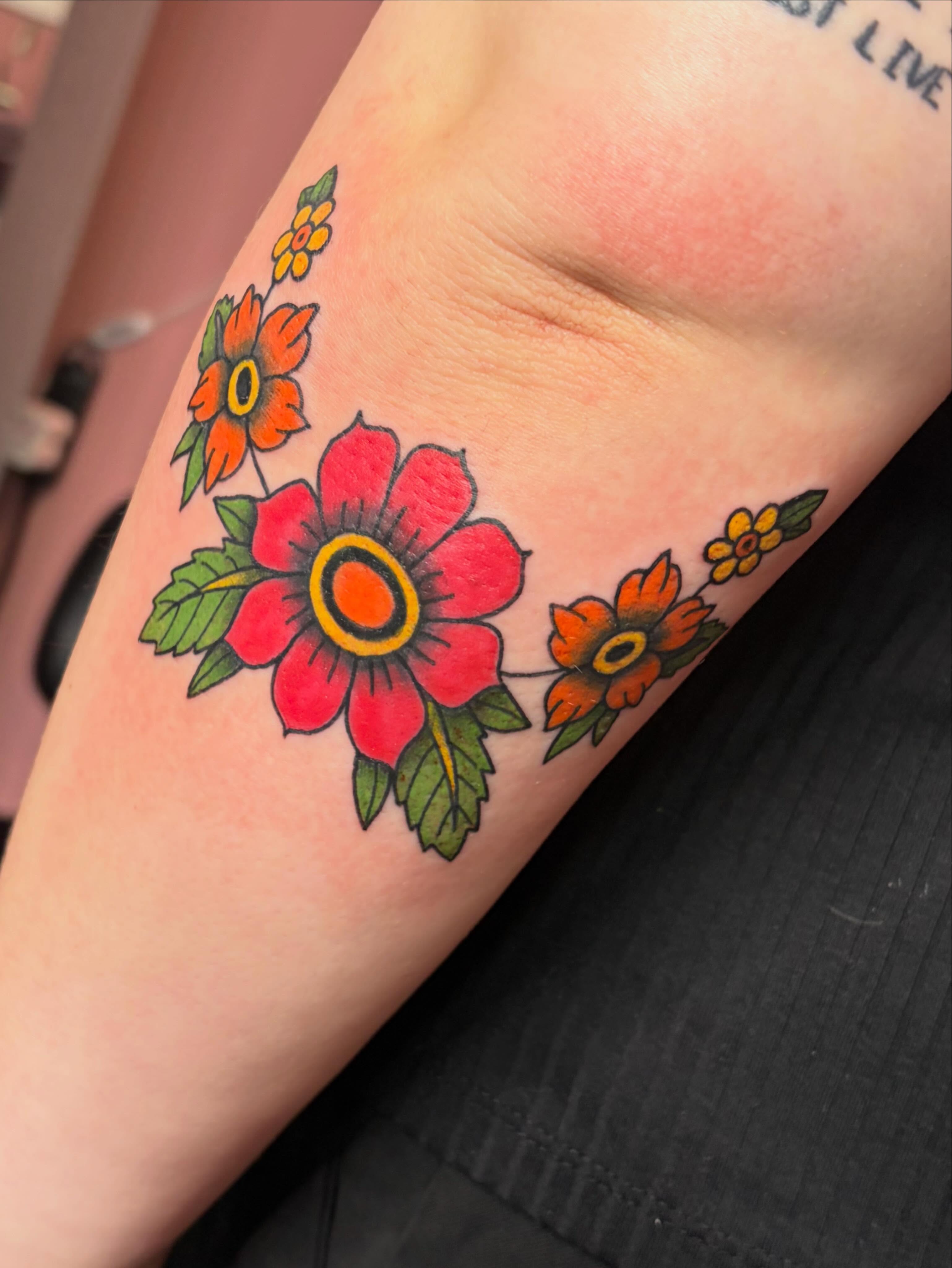 Floral arrangement American traditional tattoo on the forearm by Mary Hannah Sosdian