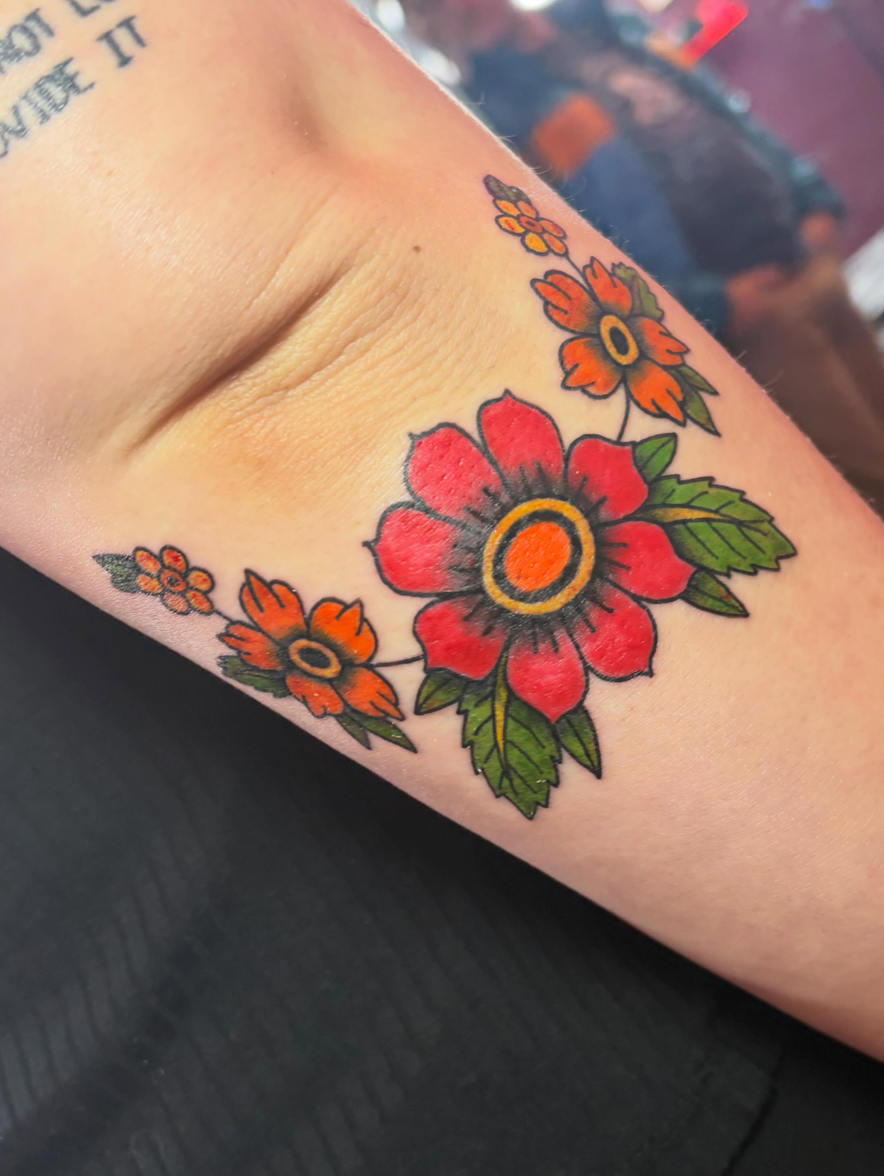 Flowers American traditional tattoo on the forearm by Mary Hannah Sosdian