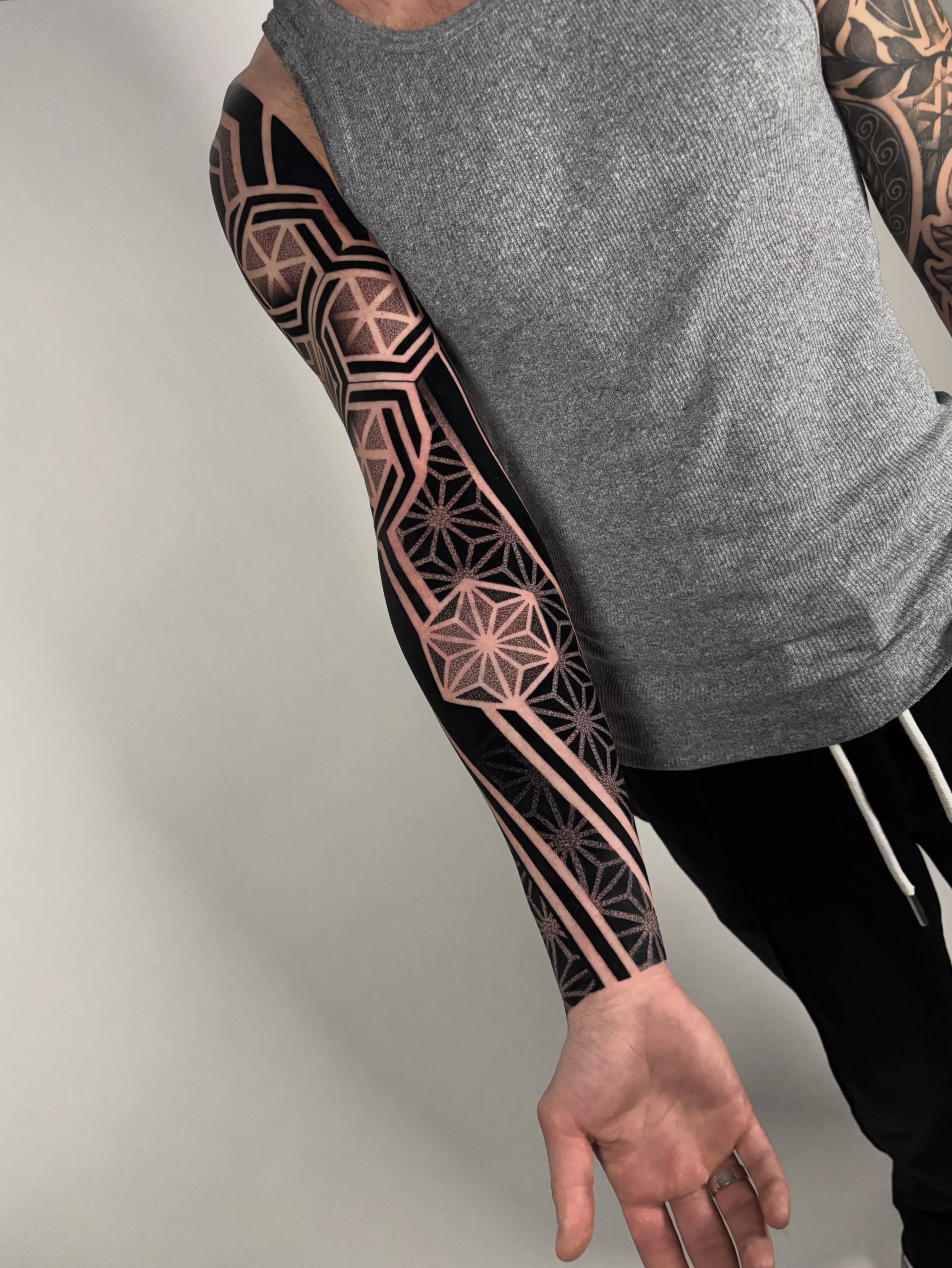 Geometric pattern geometric tattoo on the upper arm by Mitch Koch